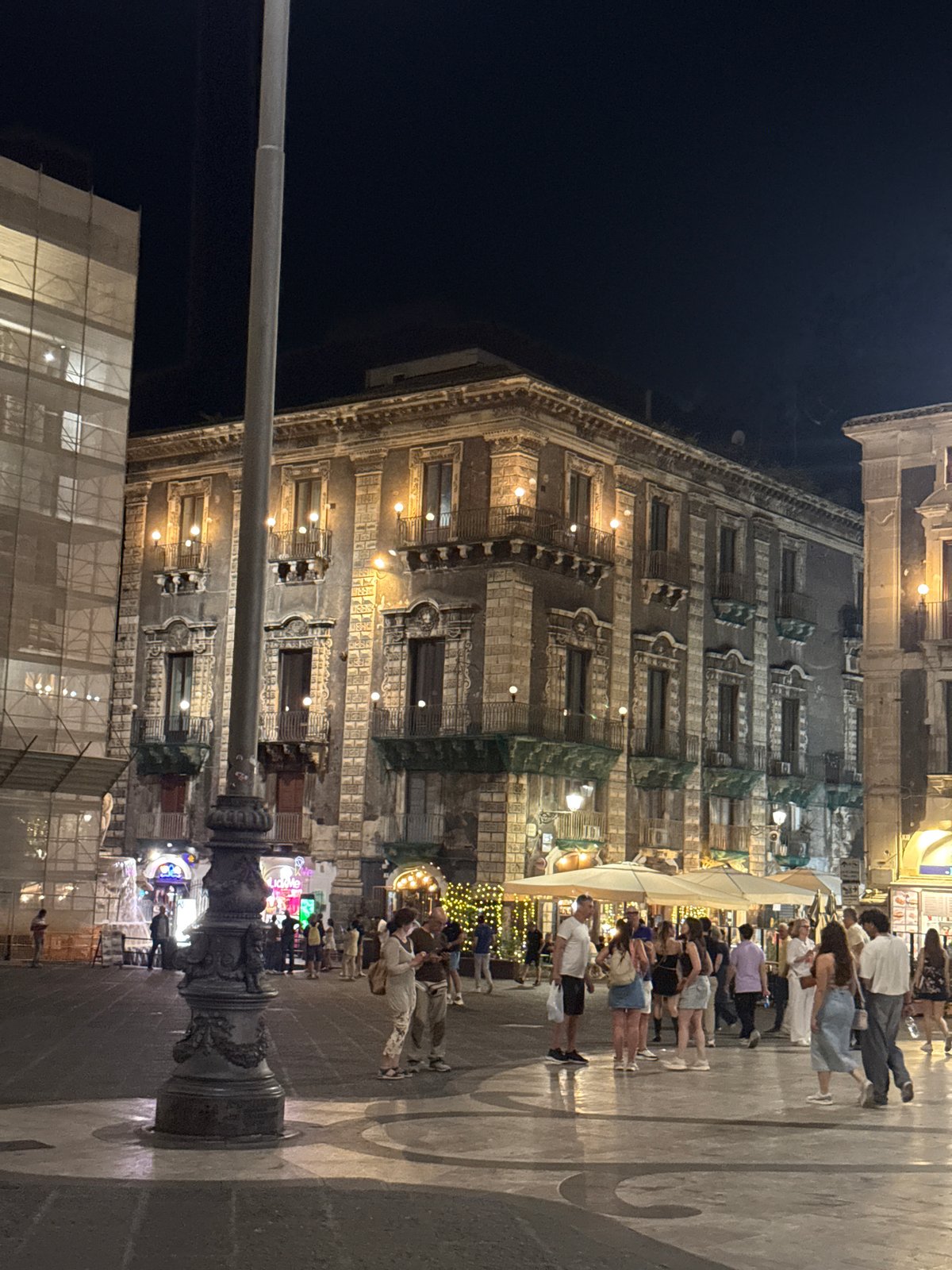 Nighttime street activity documented in historic Catania district