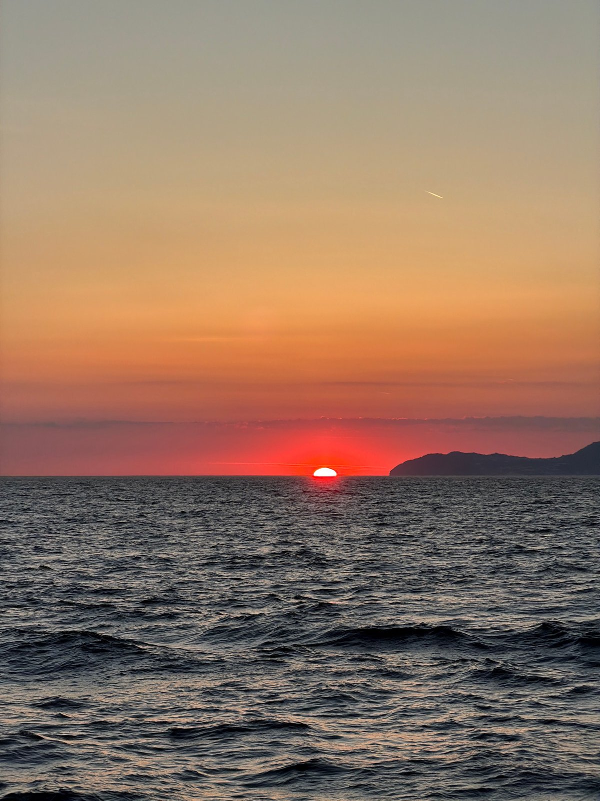 Sunset observed in Italy with unidentified linear object visible