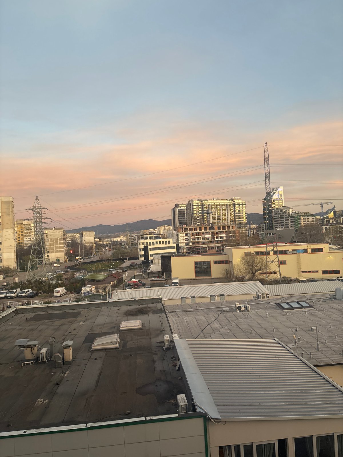 Twilight cityscape observed in Sofia with mountain backdrop