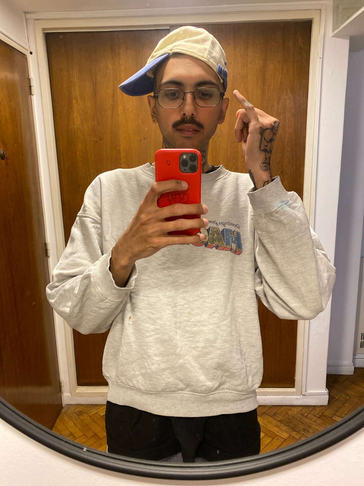 Young man takes mirror selfie in Buenos Aires apartment