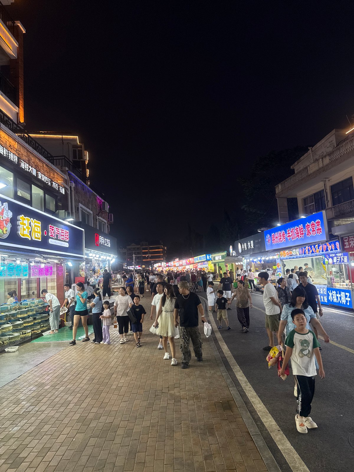 Qinhuangdao night market buzzing with food stalls and foot traffic