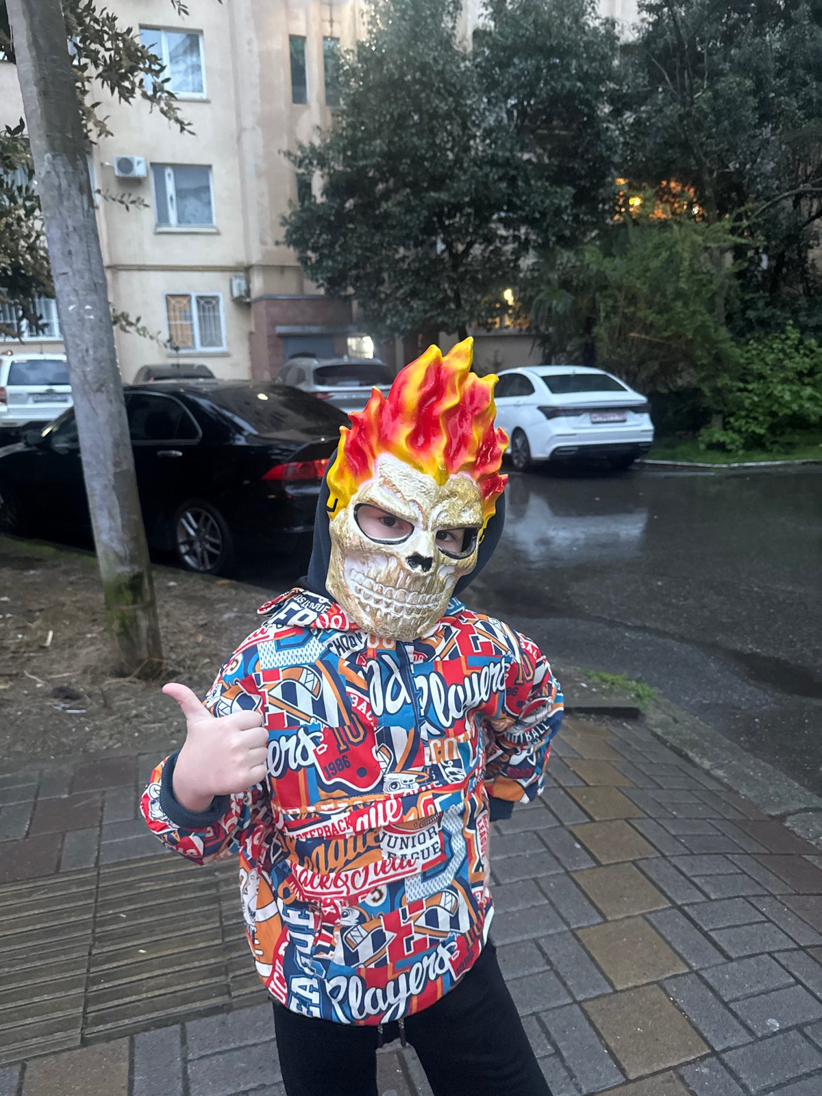 Child in Ghost Rider mask gives thumbs-down in Sochi