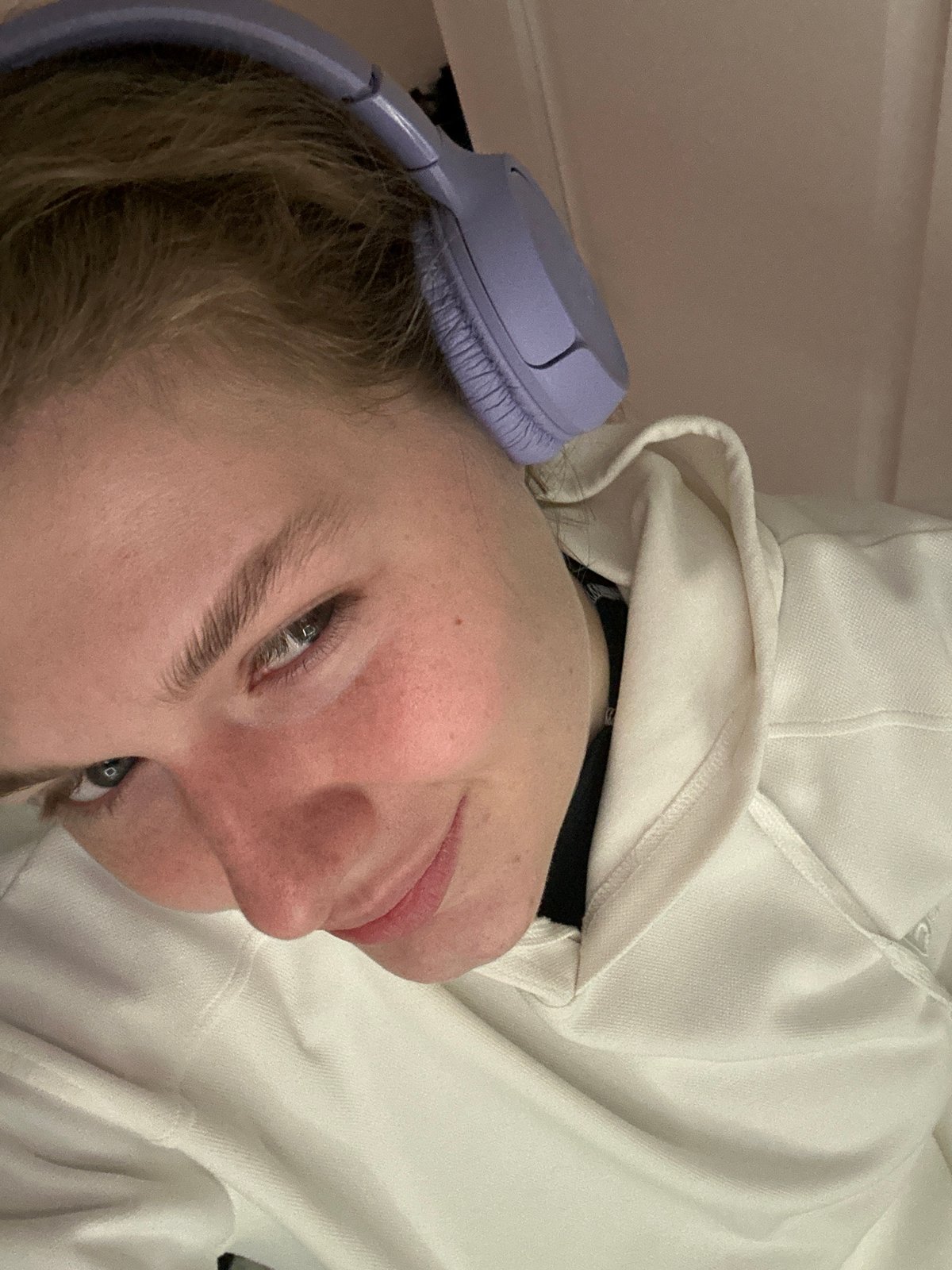 Person photographed wearing lilac headphones in Kazan