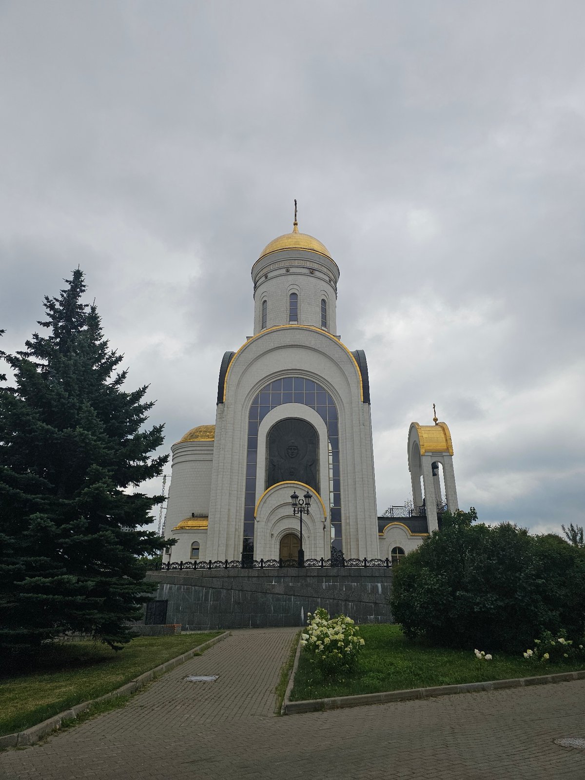 Resurrection Church's white and gold exterior under cloudy skies