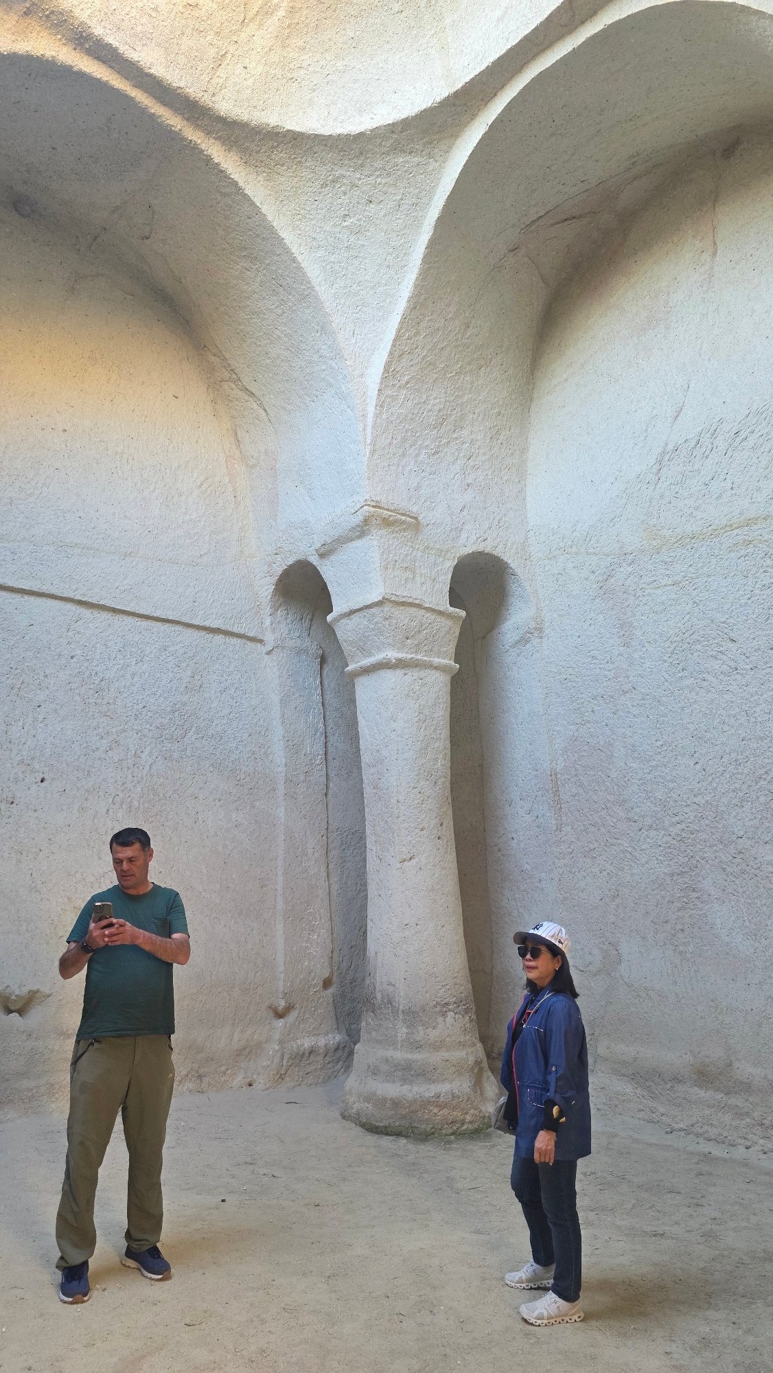 Tourists explore ancient rock-cut churches in Ürgüp, Turkey