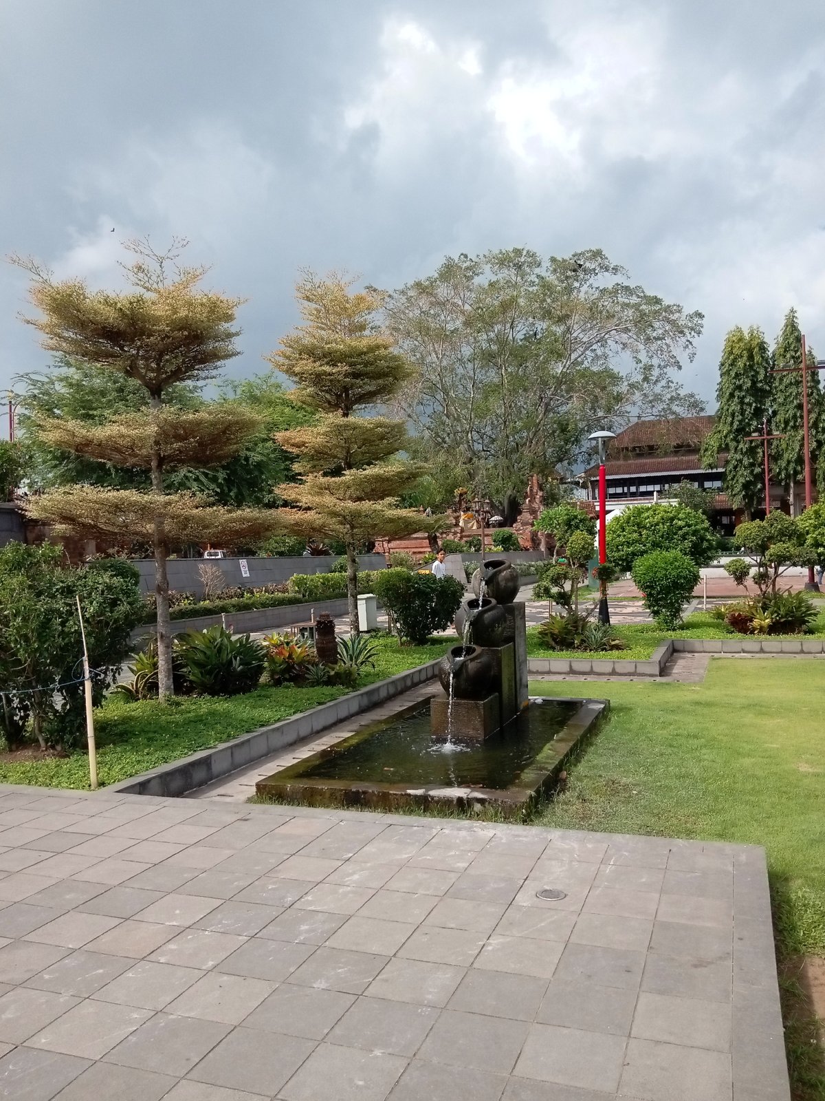 Balinese civic grounds in Gianyar, soldiers marching and statues on display