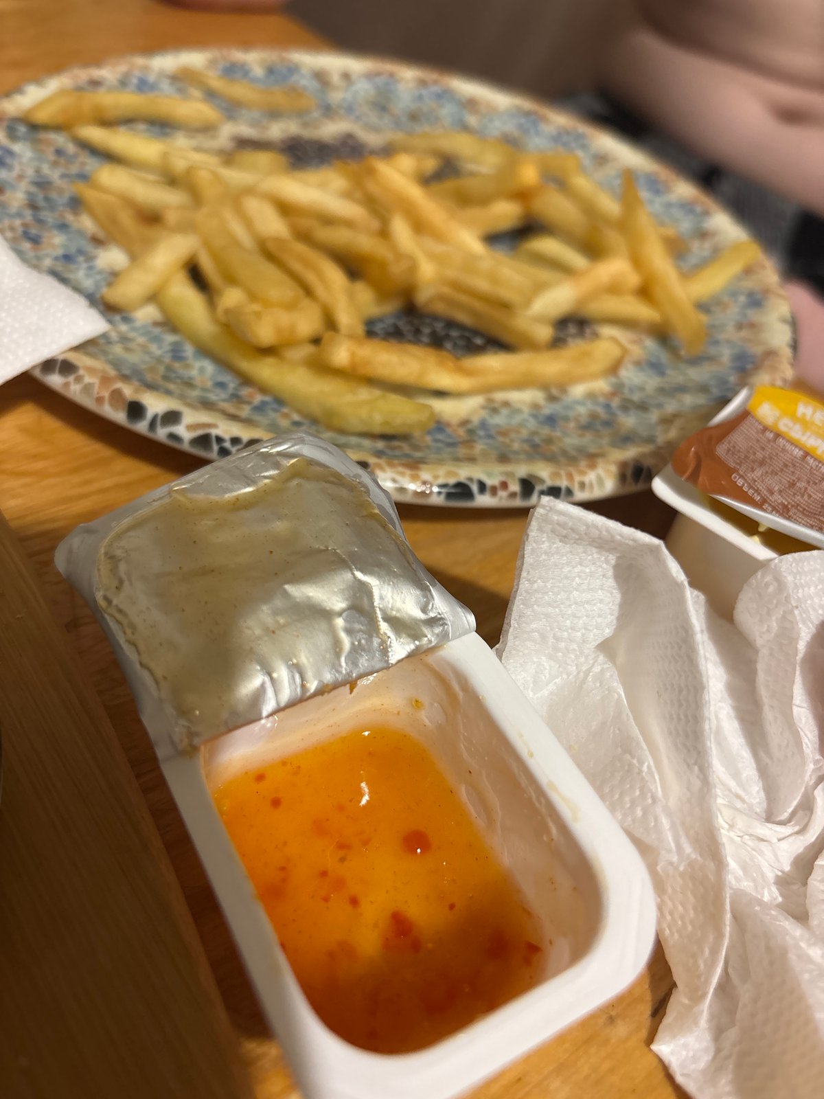 French fries served on patterned plate during casual dining