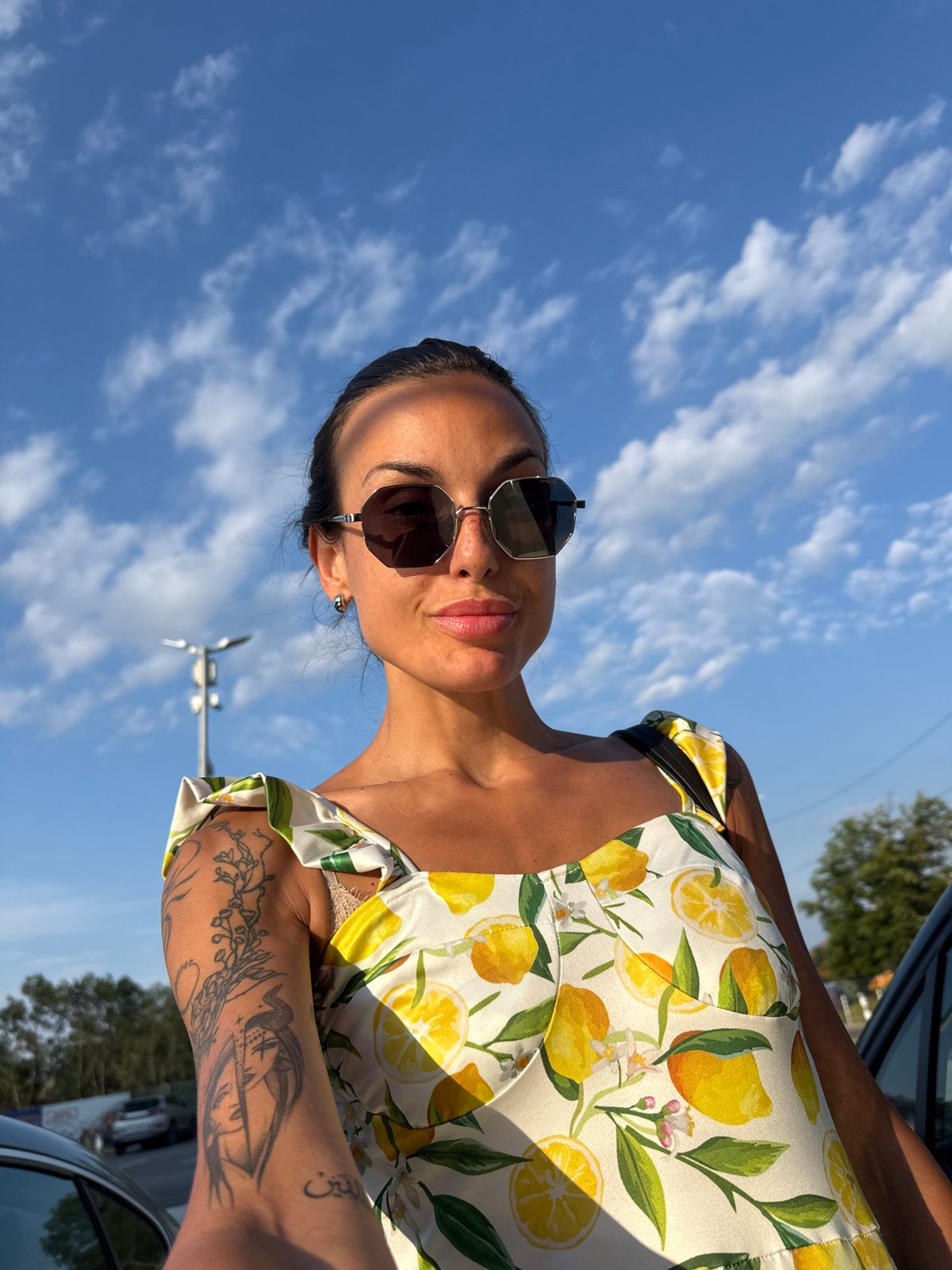 Tattooed arm and lemon print under a blue Bulgarian sky