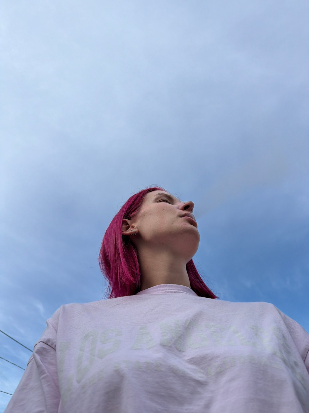 Pink hair, LA tee, Chaikovsky skies and car interior.