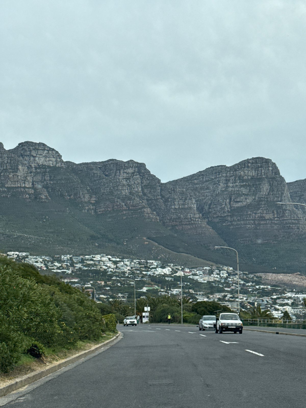 White trucks travel road near Table Mountain, Cape Town
