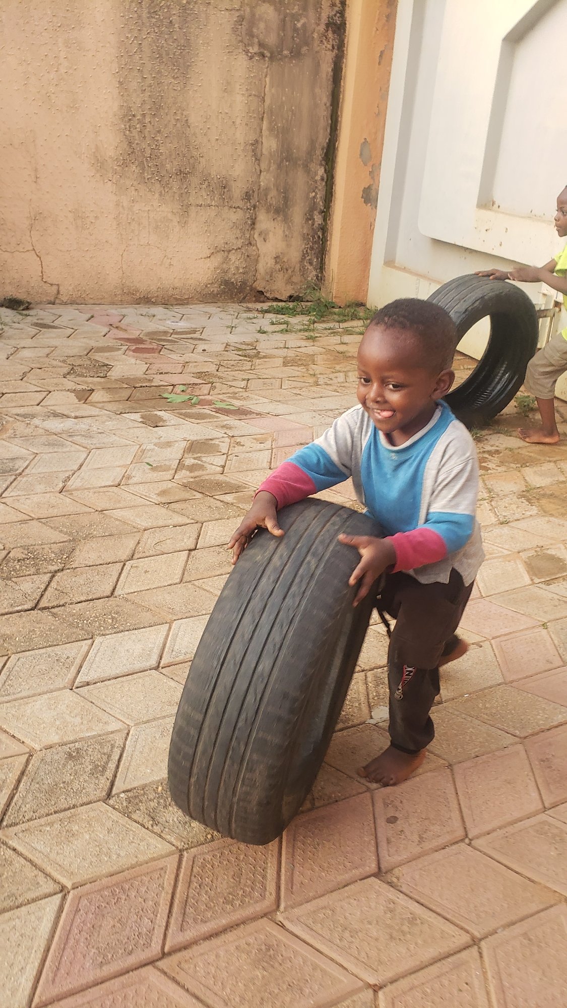 Tire play in a Sabon Tasha courtyard, Nigeria