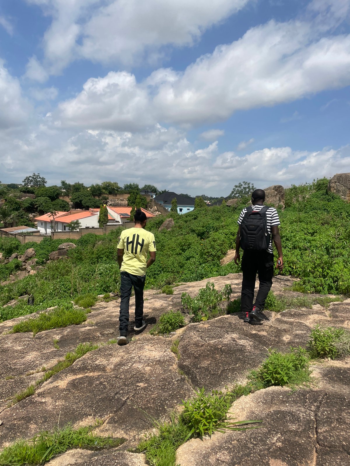 Hiking through a rocky hillside above a dense settlement