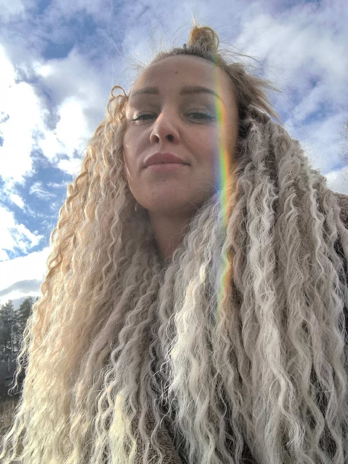Woman photographed with rainbow backdrop in Noviy, Russia