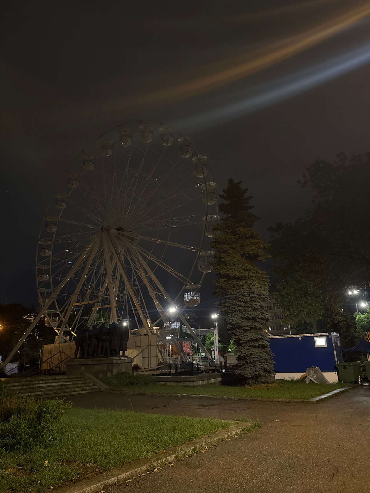 Evening fairground scene with illuminated Ferris wheel captured in Sofia