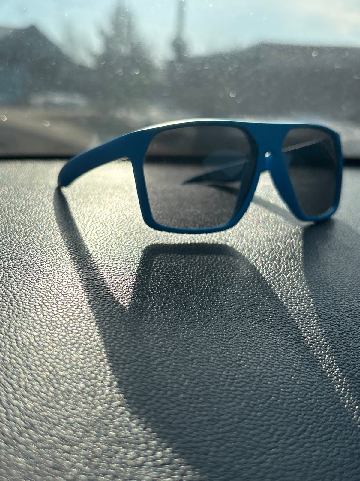 Blue sunglasses on vehicle dashboard in Chaikovsky, Russia