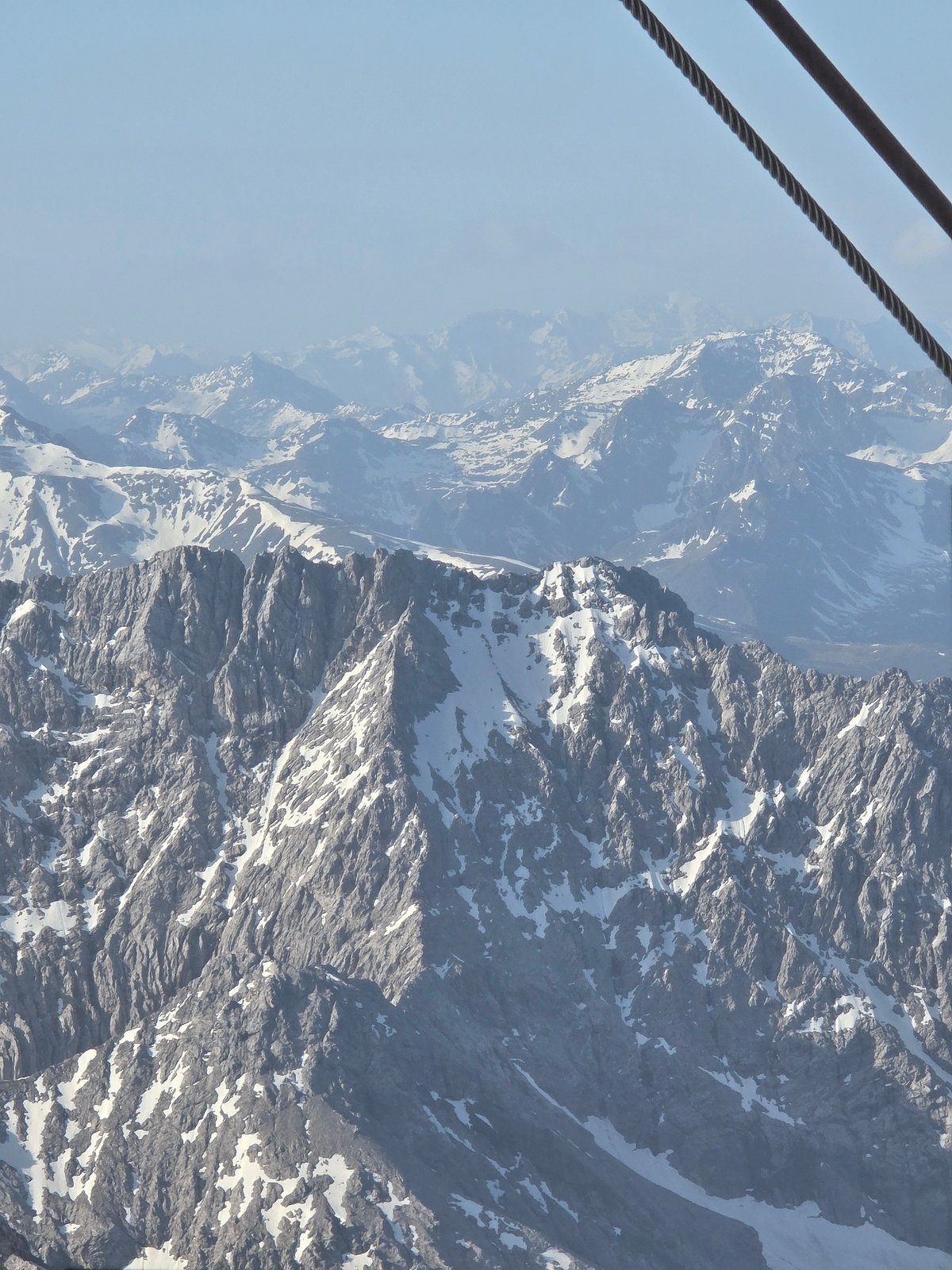Cable car riders document Alpine views near Grainau, Germany