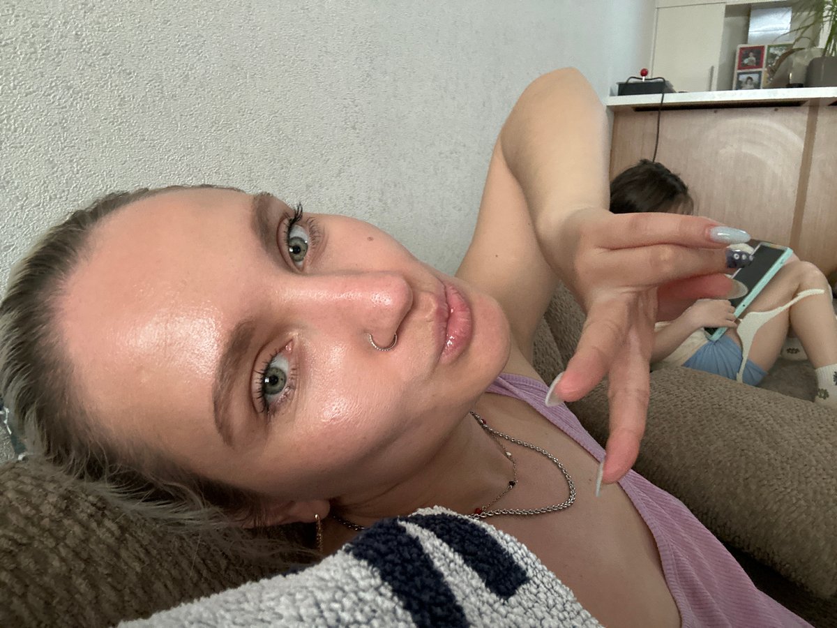 Woman takes selfies on couch in Esenyurt, Turkey