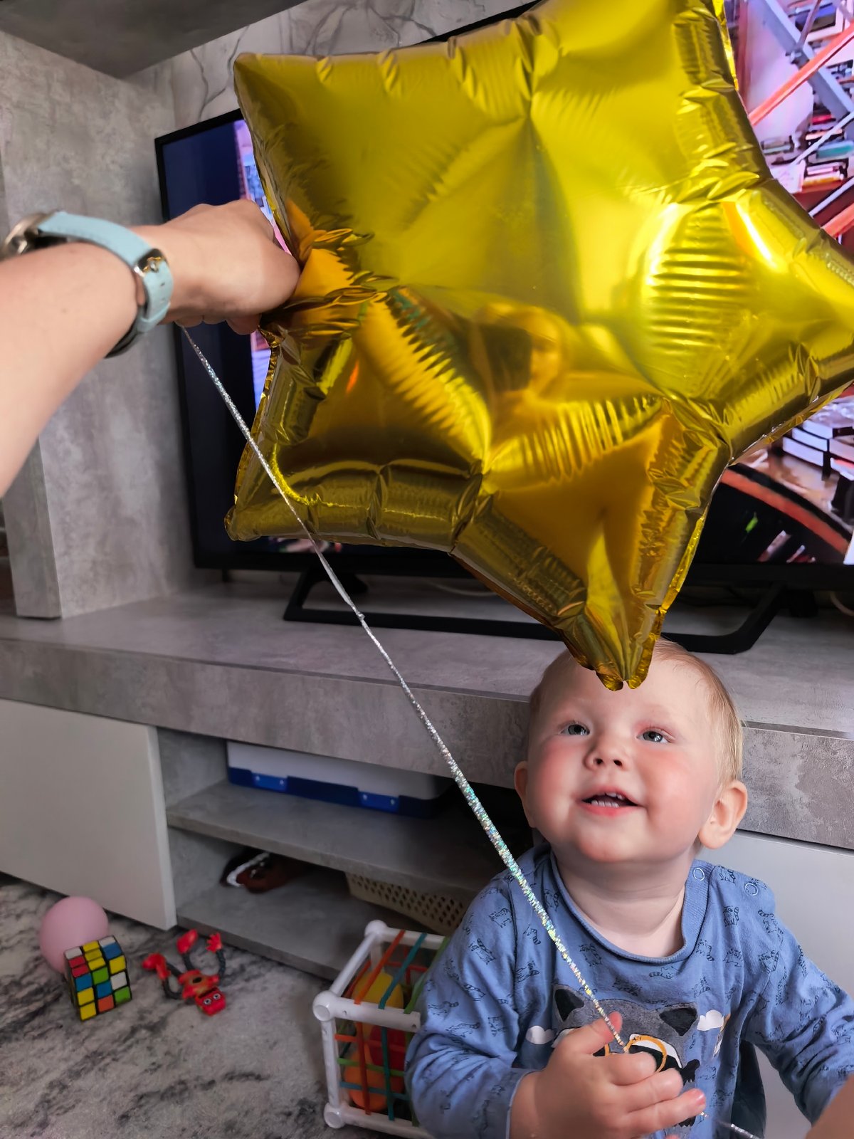 Toddler plays with balloons, toys during family time in Sterlitamak