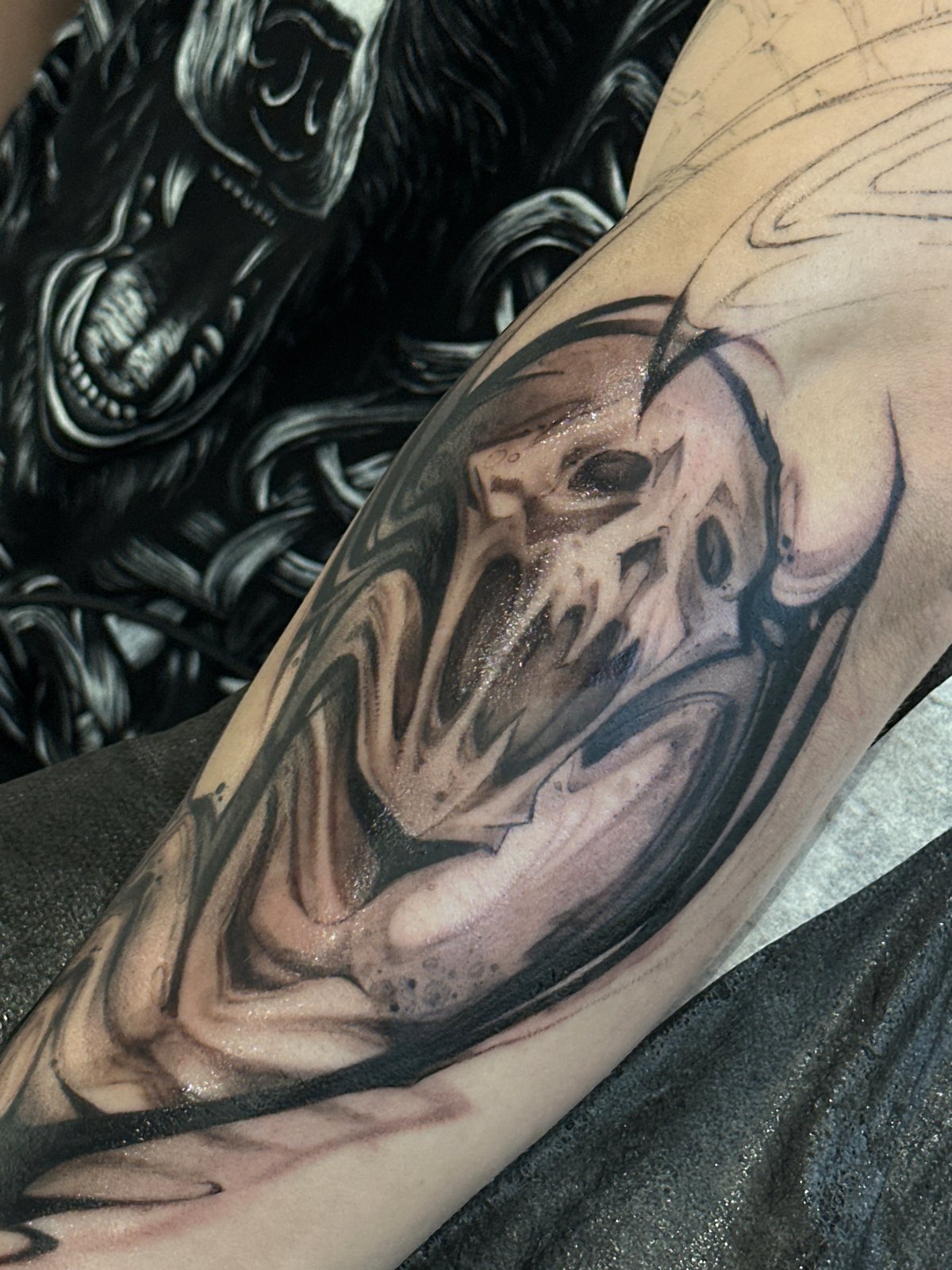 Partial skull tattoo documented in progress in Moscow