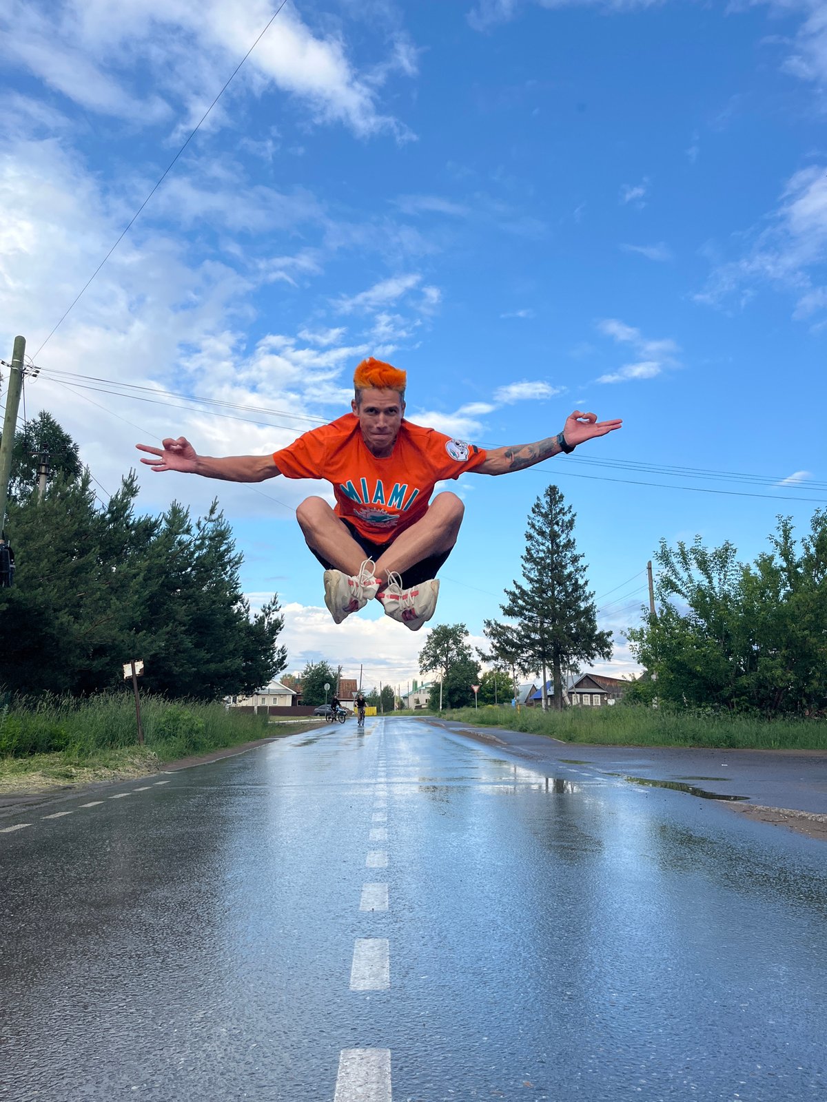 Young men perform stunts on flooded roads in Chaikovsky