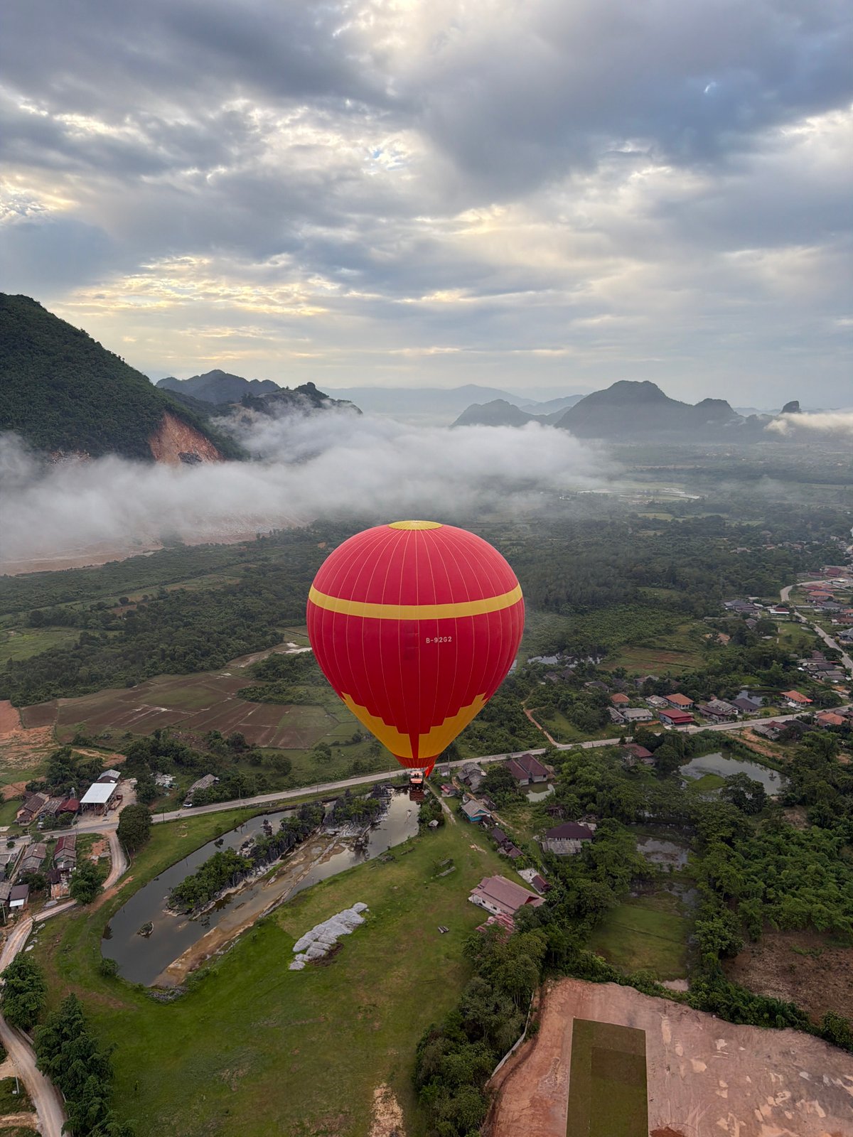 Hot air balloon ride over misty karst mountains near Vang Vieng, Laos