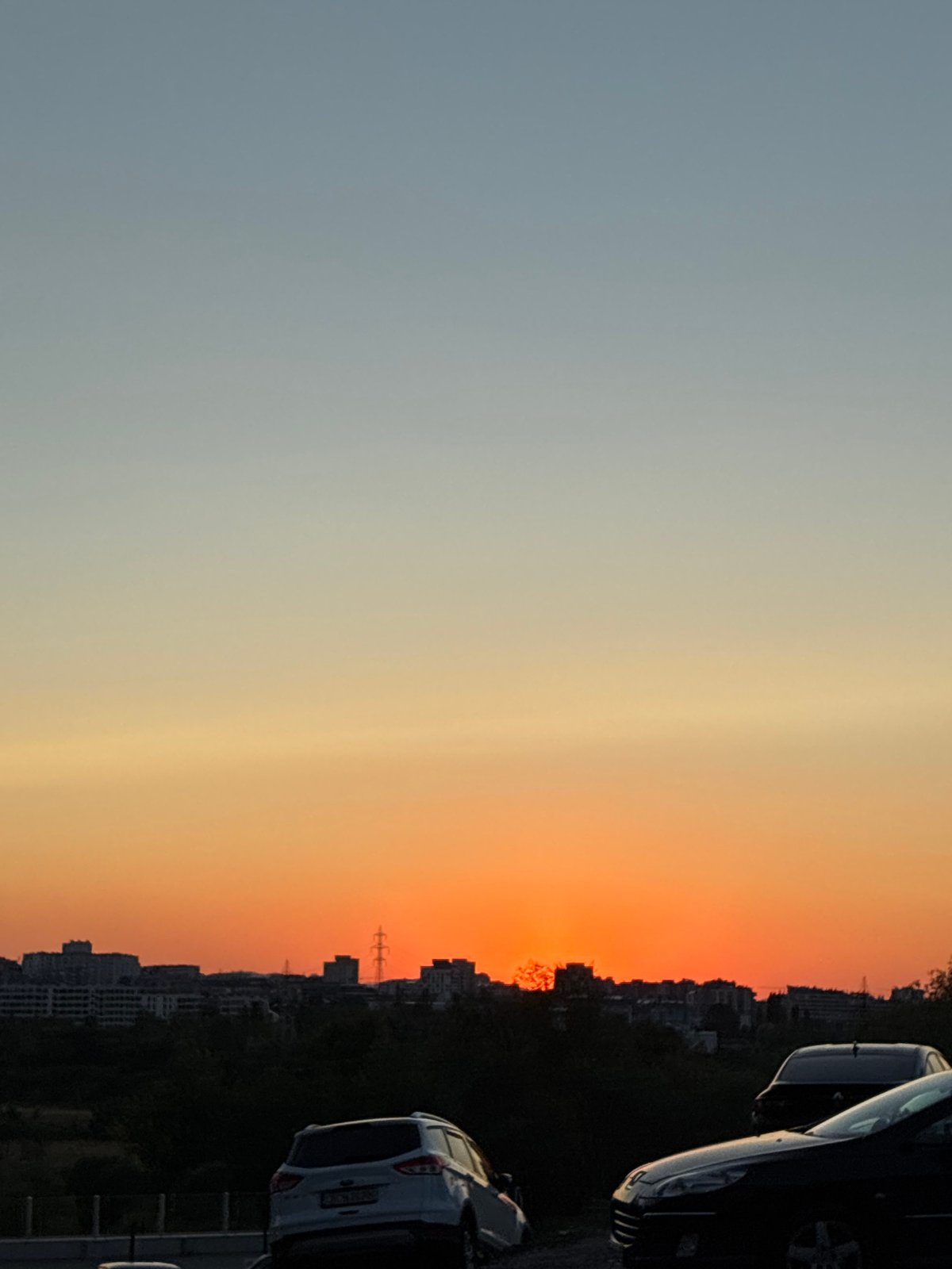 Sunset over Sofia's skyline, shot from above at golden hour