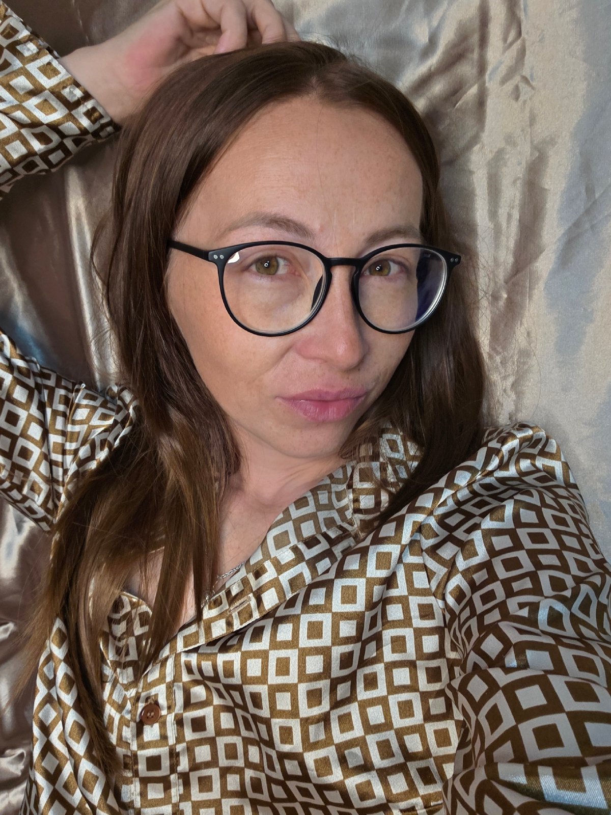 Cozy night in with satin sheets, a book, and downtime
