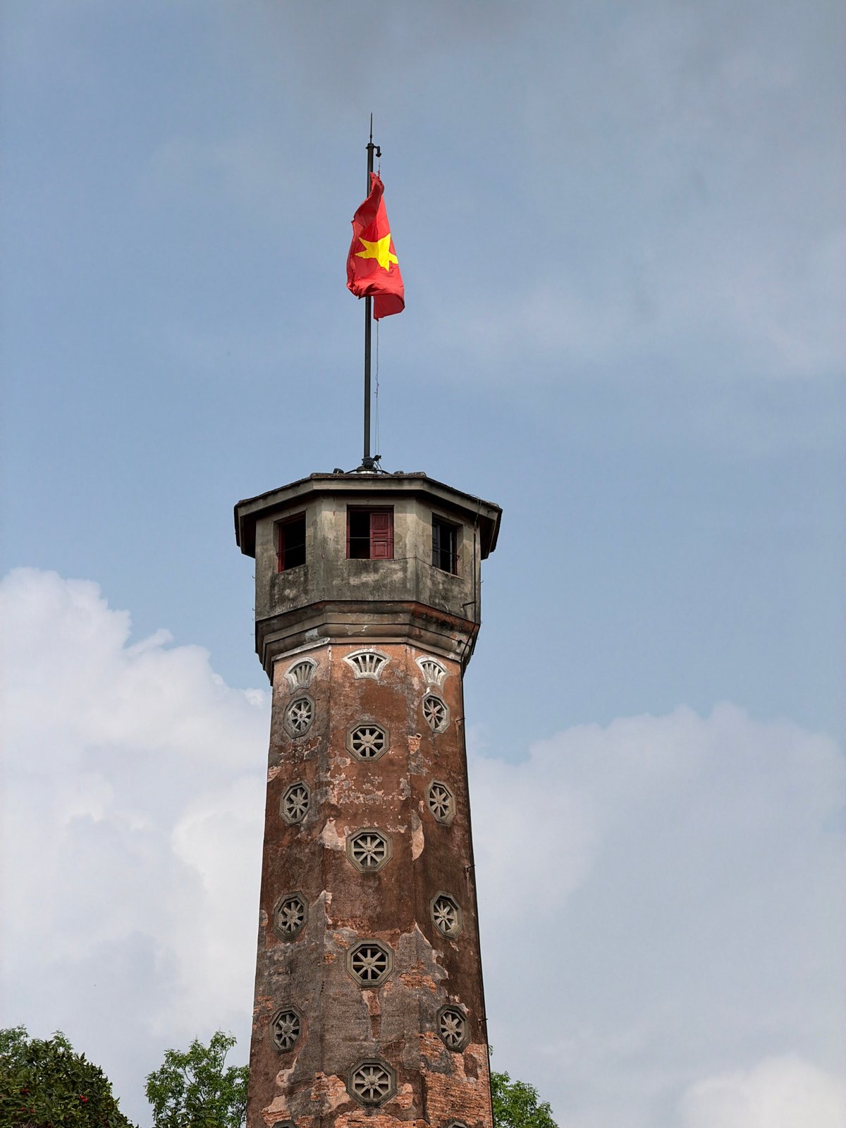 Vietnamese flag flies atop historic Hanoi tower