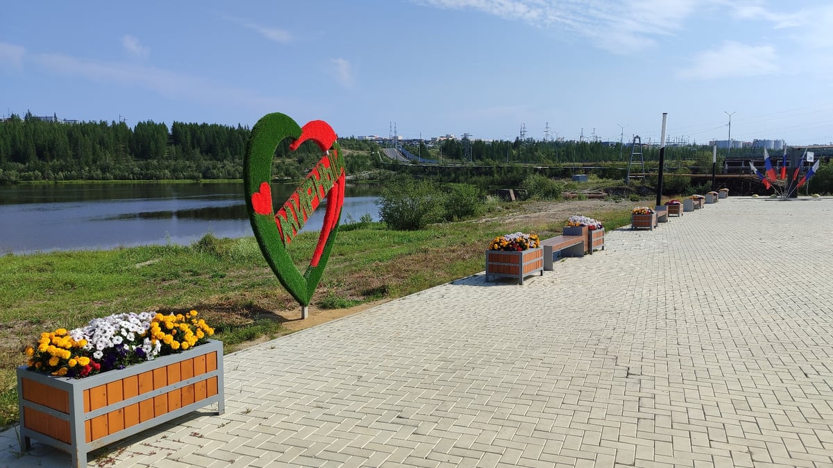 Strolling Mirny's riverside promenade on a summer morning