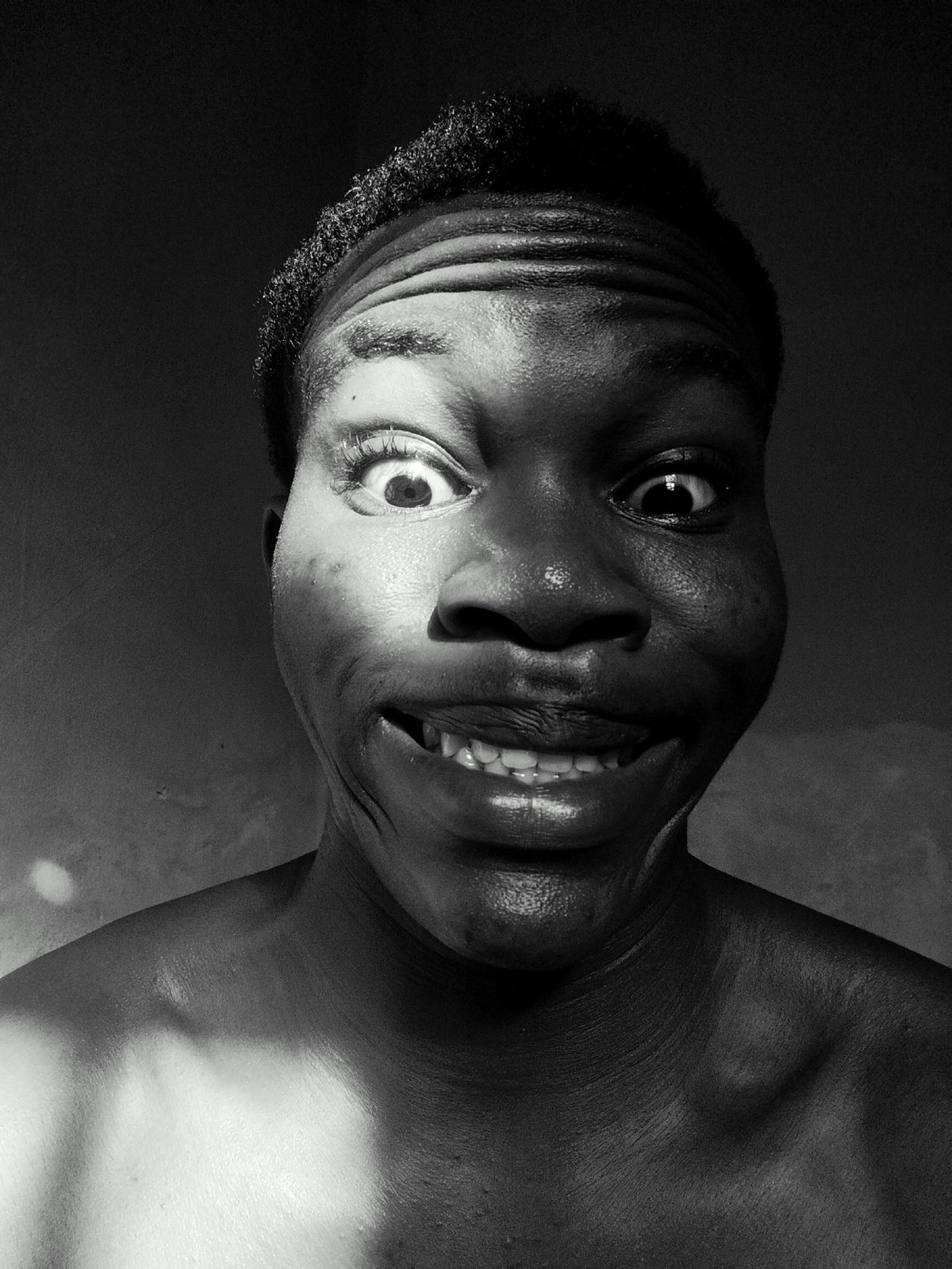 Portrait captures person's exaggerated comedic expression in black-and-white photograph
