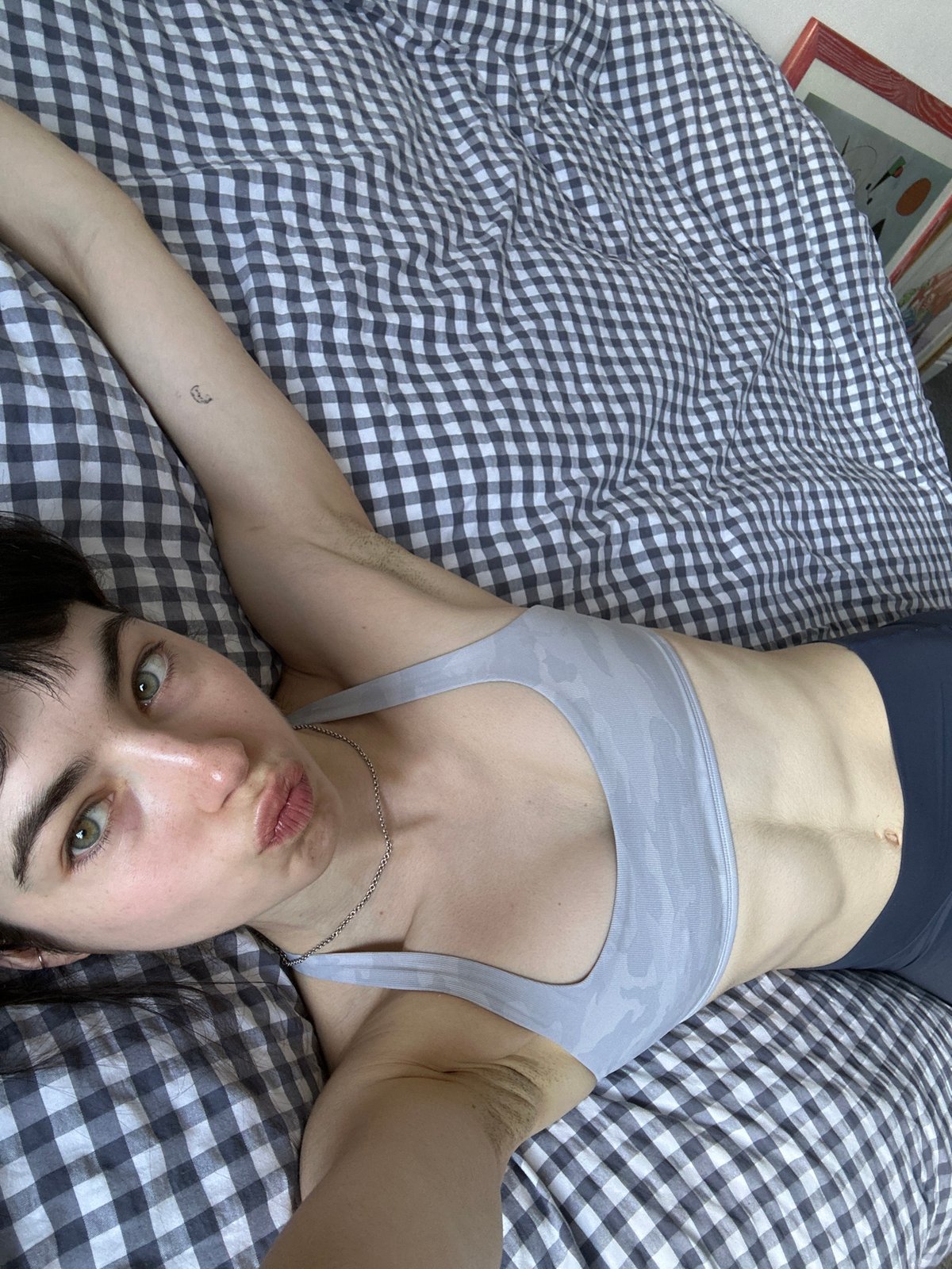 Person resting on bed observed in London residential setting
