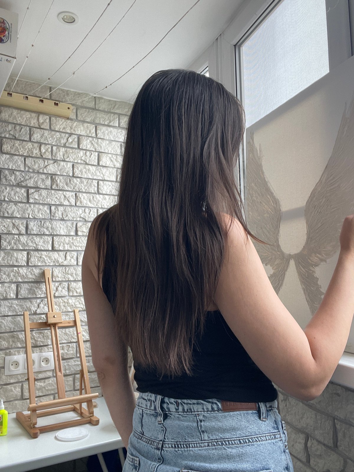 Artist creates textured wing painting with palette knife indoors