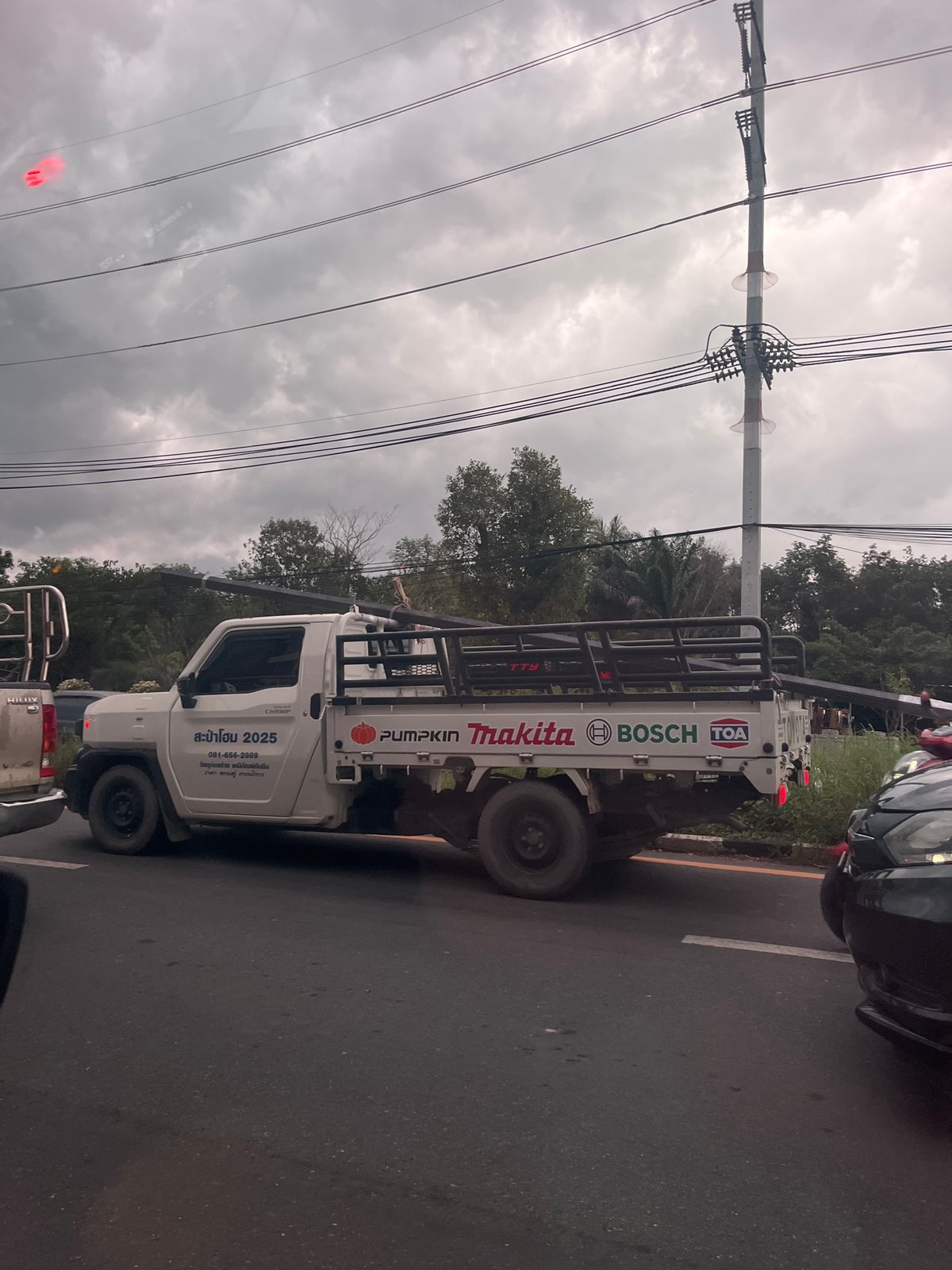 Traffic jam forms under storm clouds in Si Sunthon