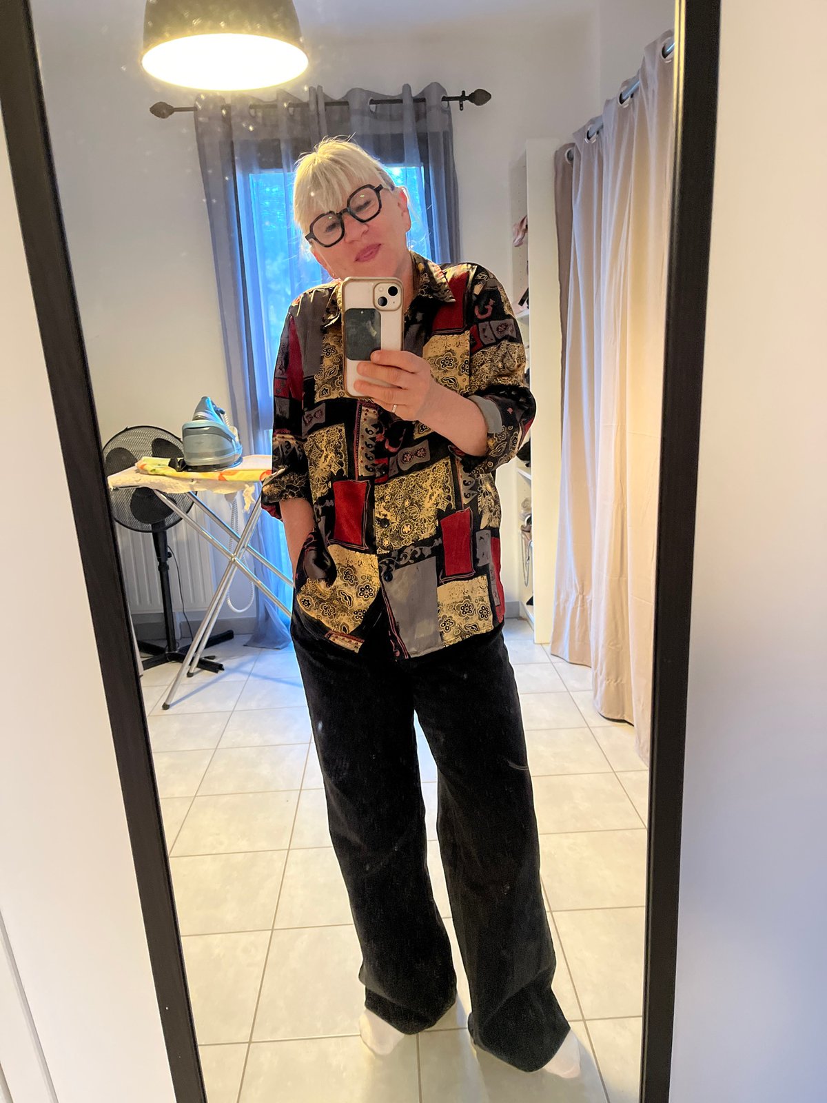Woman takes mirror selfie in home in Chambœuf, France