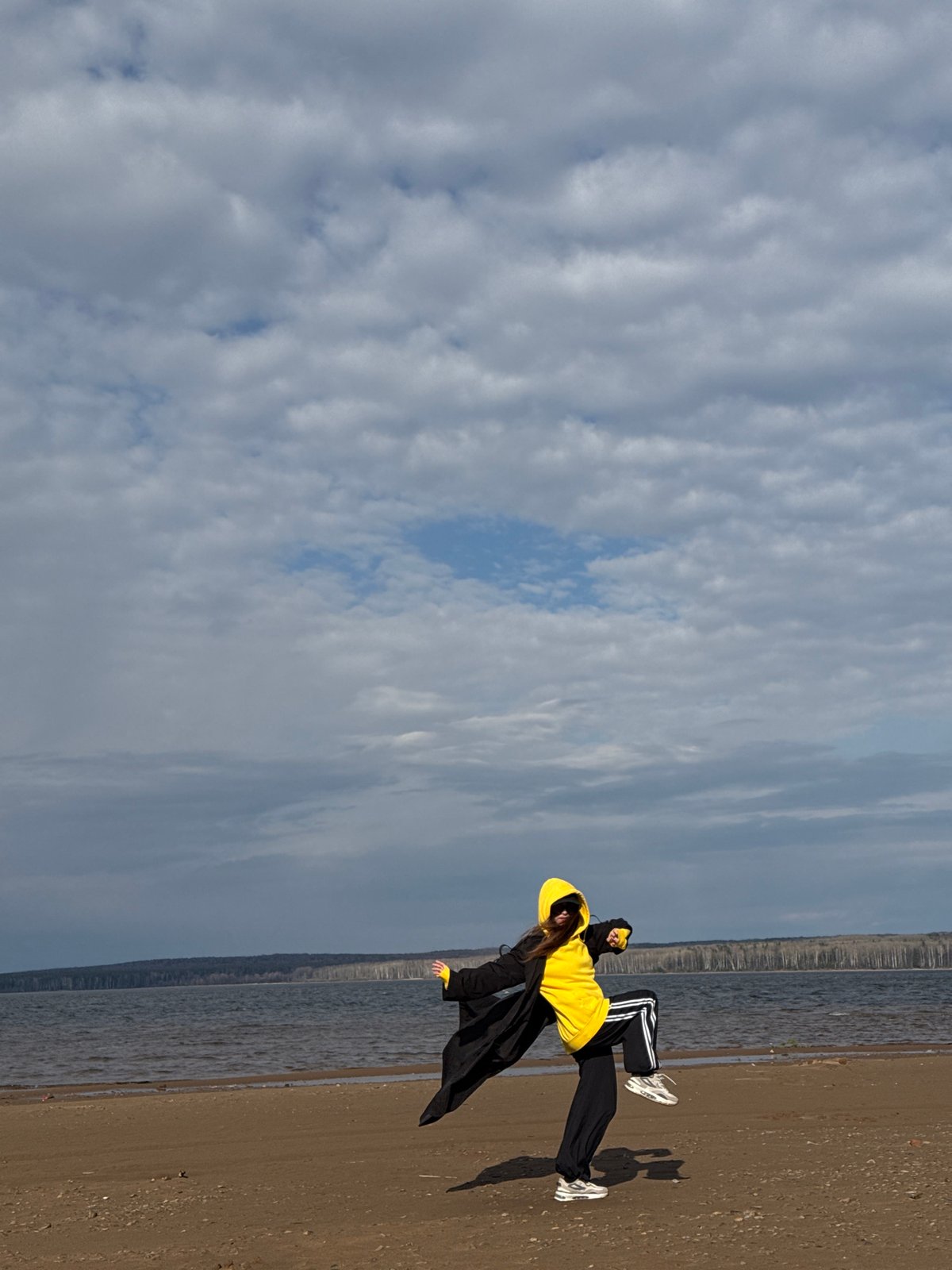 Person walks and poses on beach in Chaikovsky, Russia