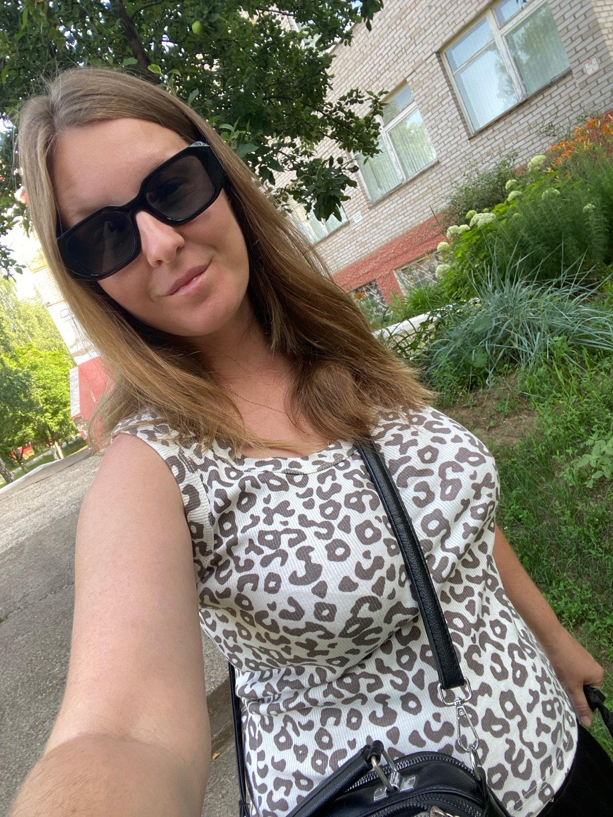 Outdoor selfie in front of a brick building, Noviy