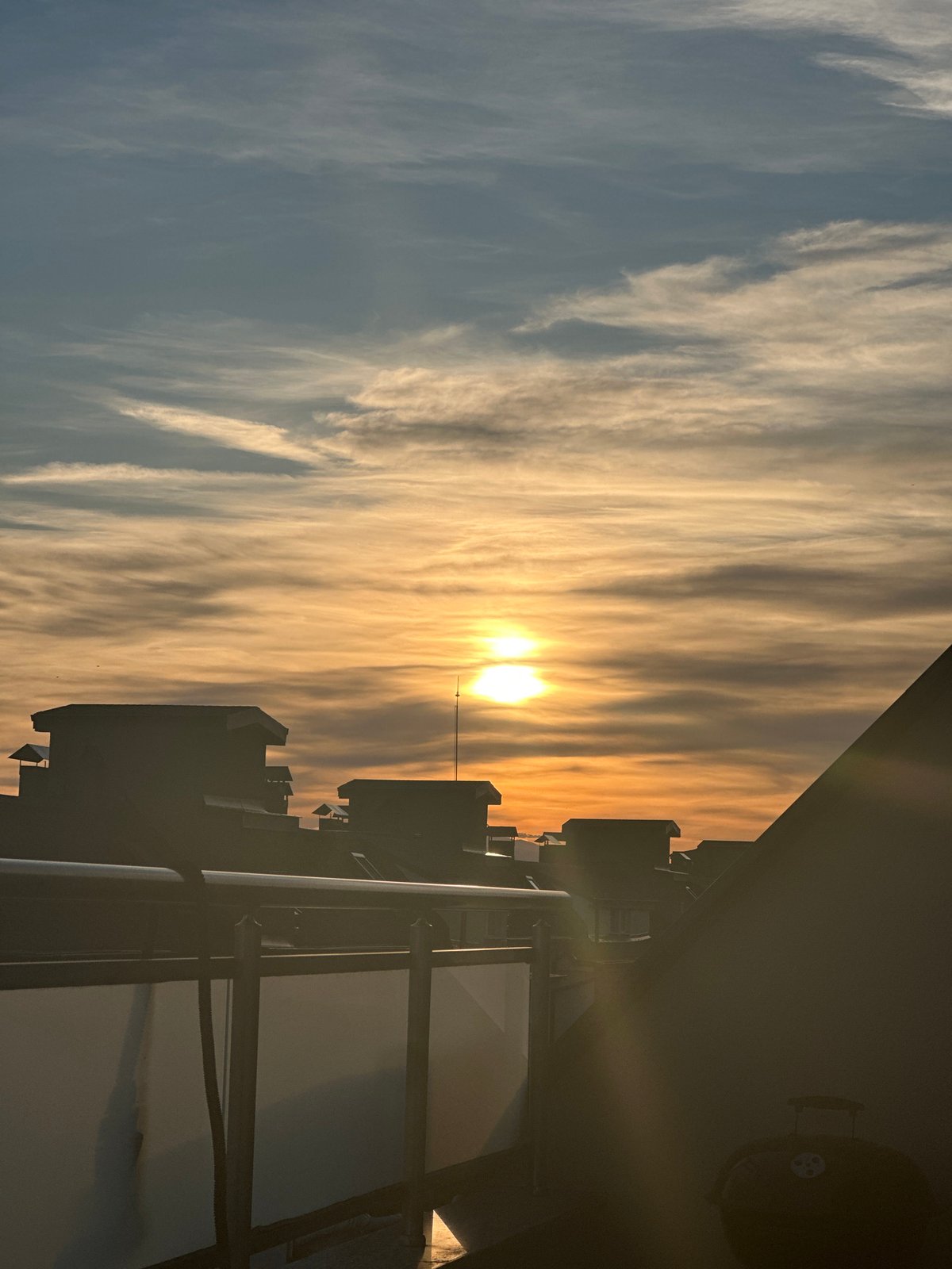 Sunset observed over Plovdiv cityscape with colorful cloud formations