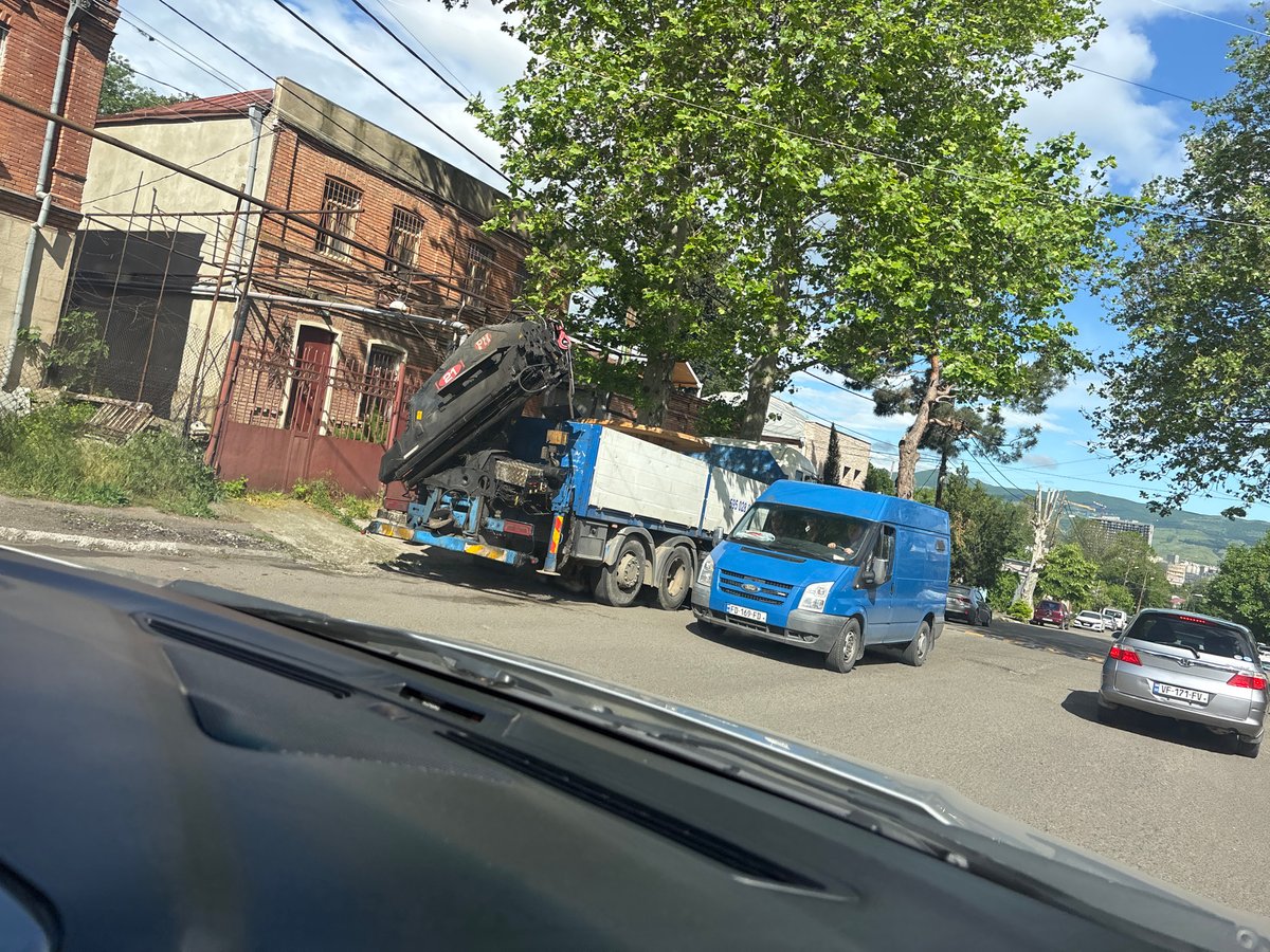 Morning street traffic documented on Tbilisi cobblestone roads