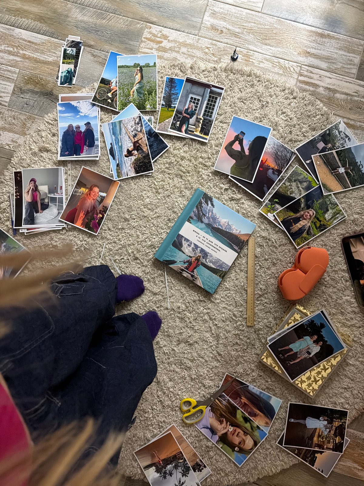 Woman takes selfies, photos arranged on rug in Russia