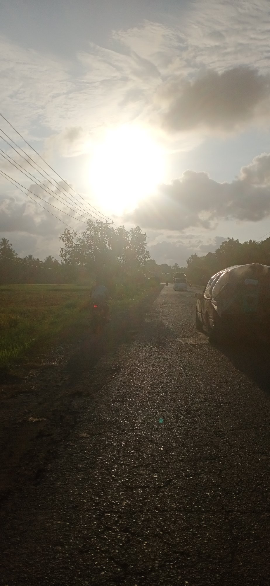Sunlit rural road observed in Lhokseumawe, Indonesia