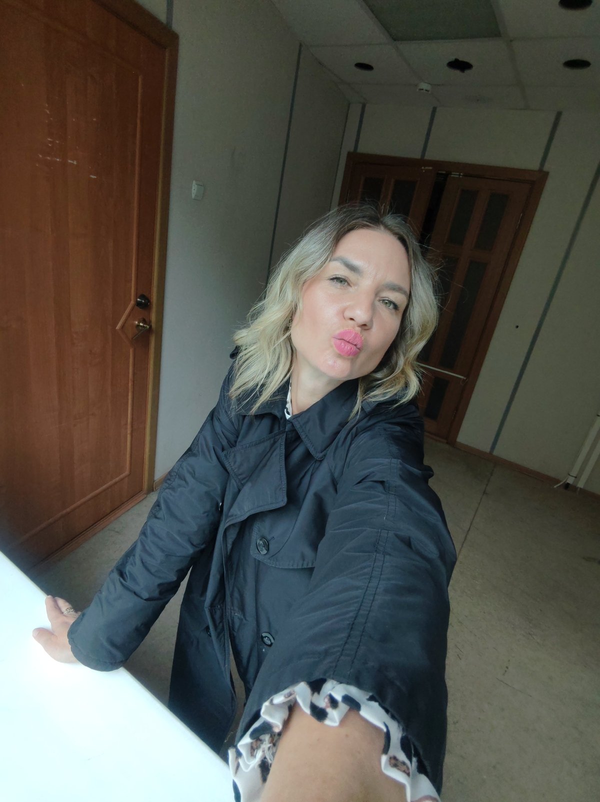 Woman Takes Multiple Selfies in Empty Indoor Space