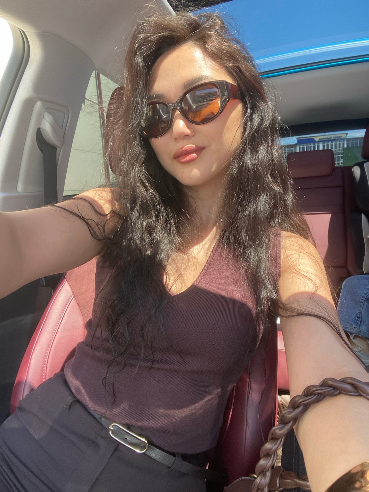 Woman takes casual selfies in car during sunny Sochi morning