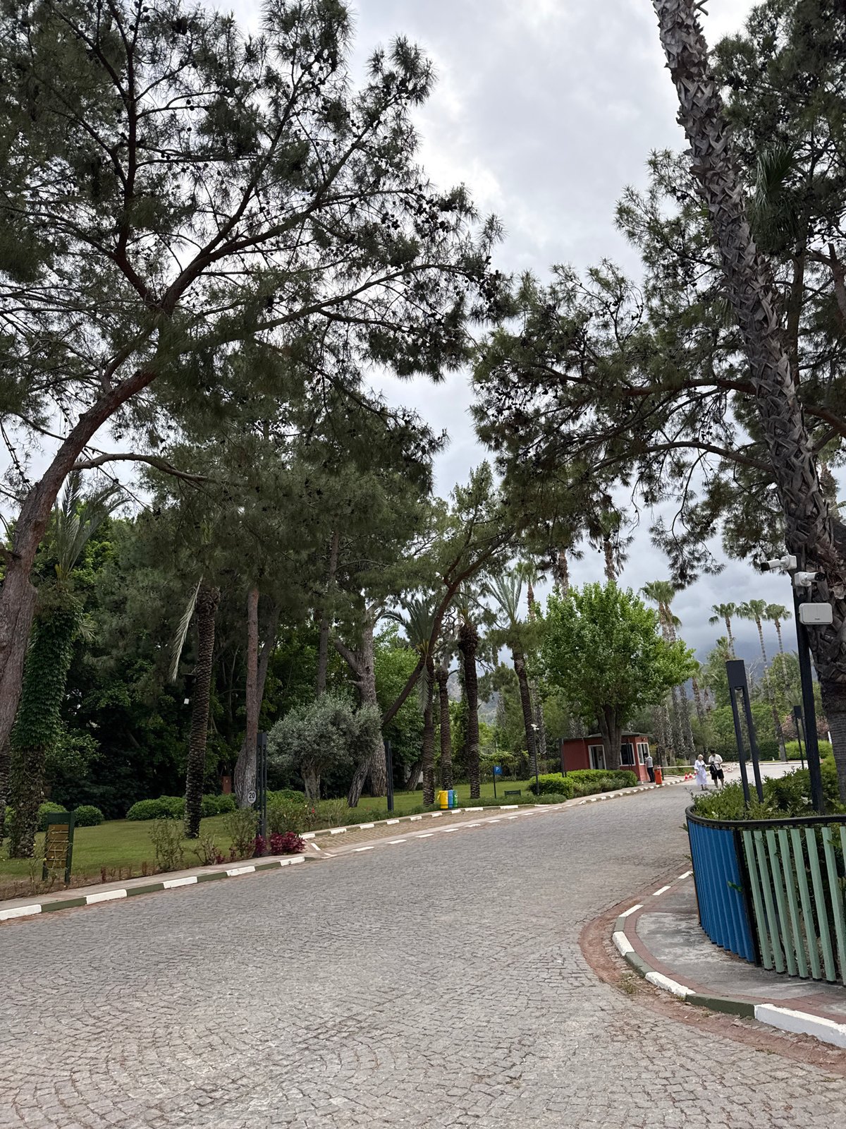 Tourist explores Kemer resort areas with tennis rackets