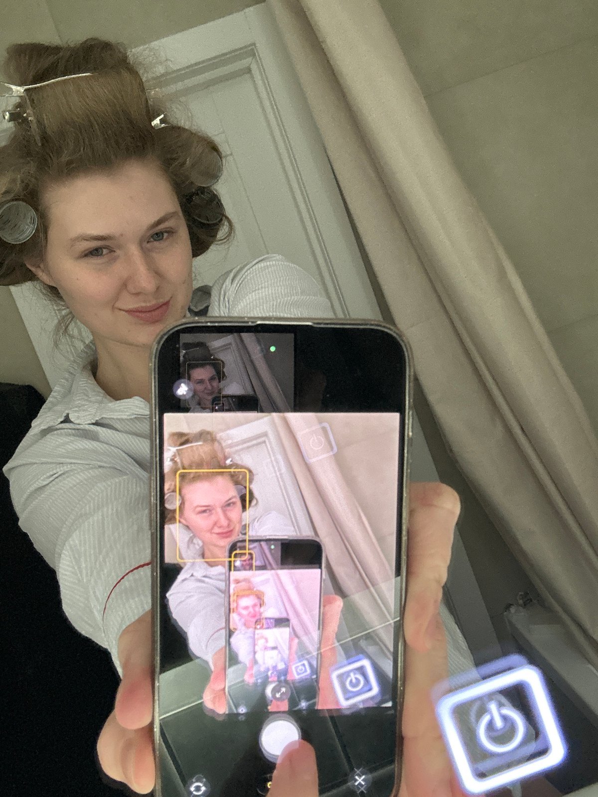 Woman takes mirror selfie with hair rollers in Russia