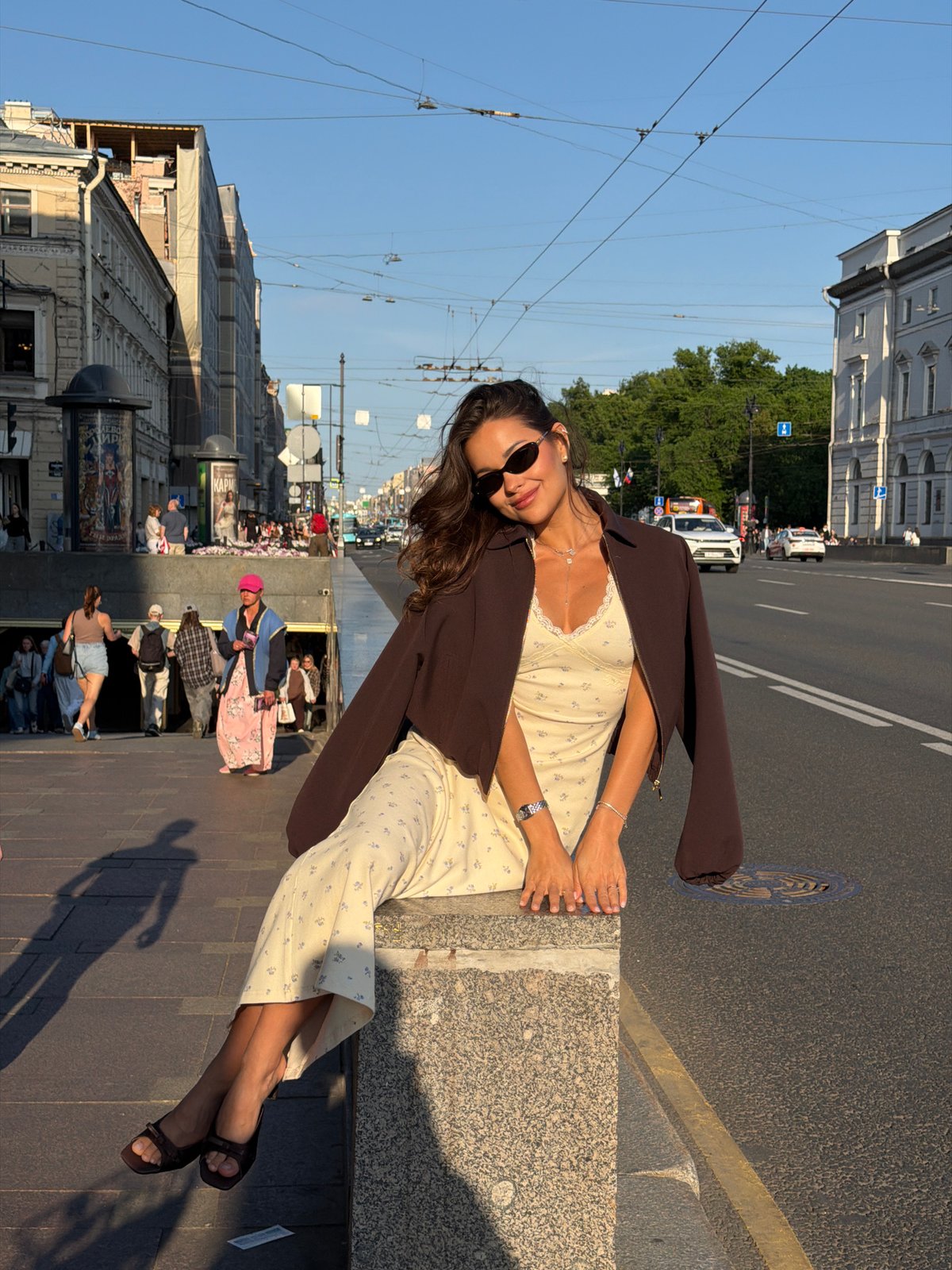 Woman enjoys sunny afternoon with flowers in Saint Petersburg