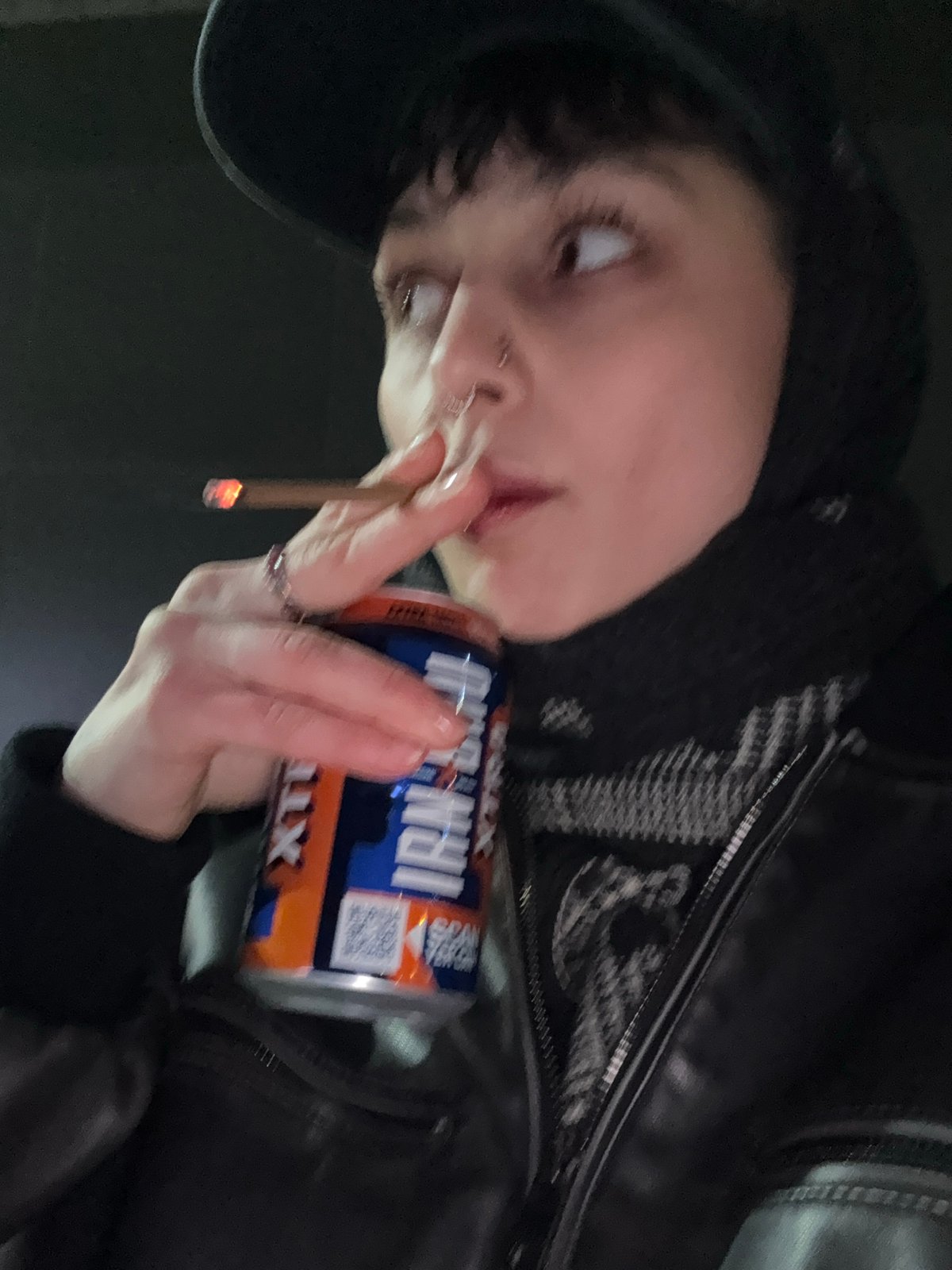Person smoking cigarettes near overflowing ashtray in Moscow