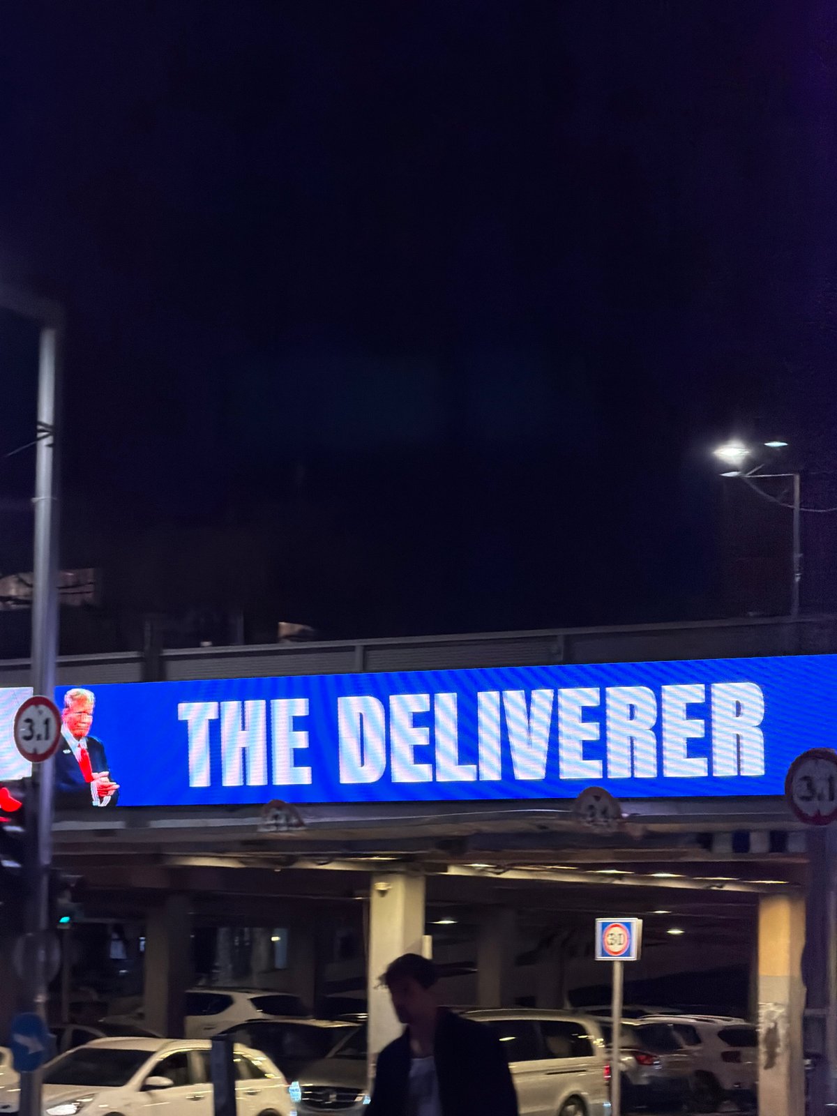 Tel Aviv evening captures billboard message and dog interaction
