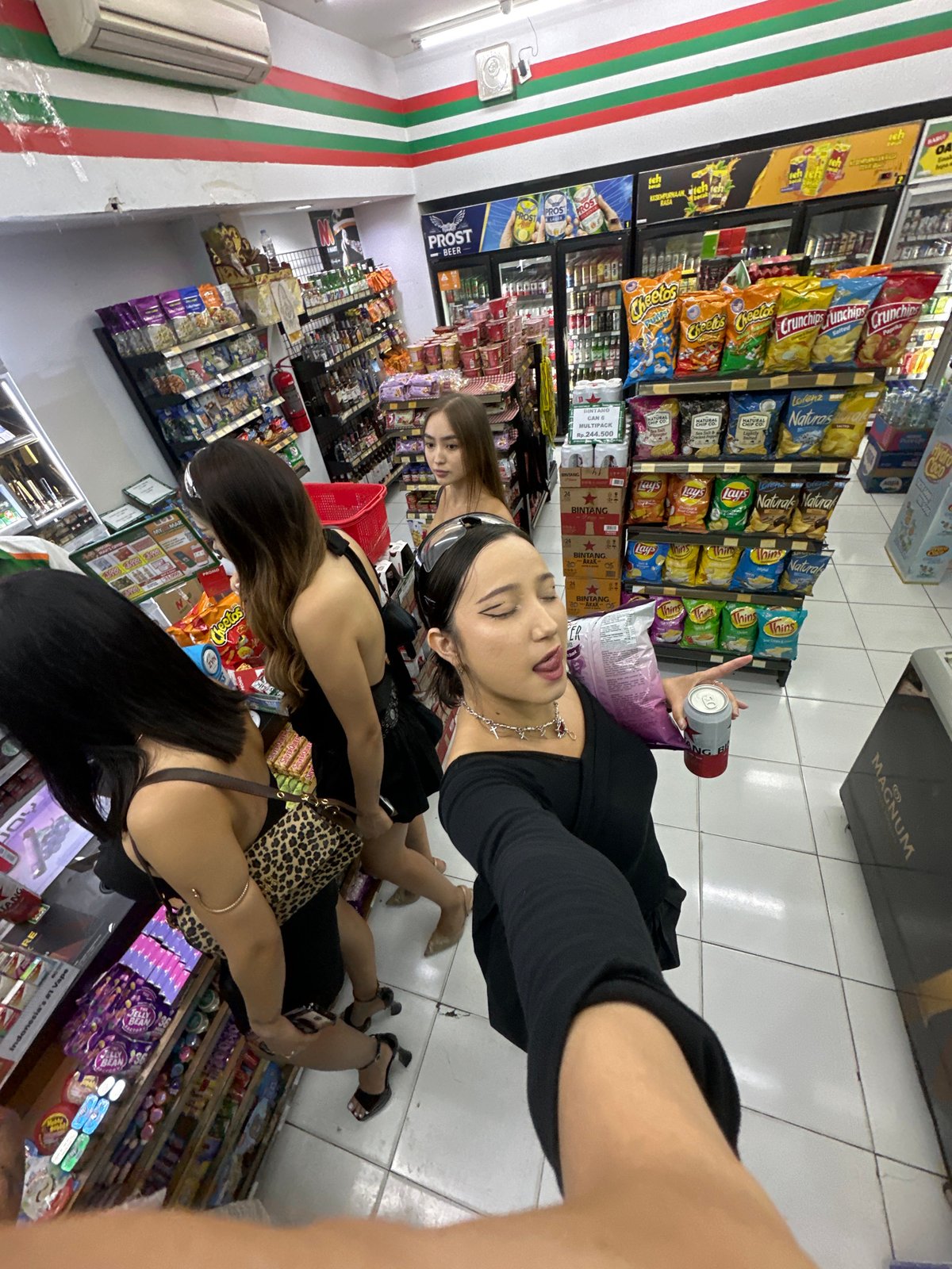 Young women shop, pose for photos at North Kuta convenience store