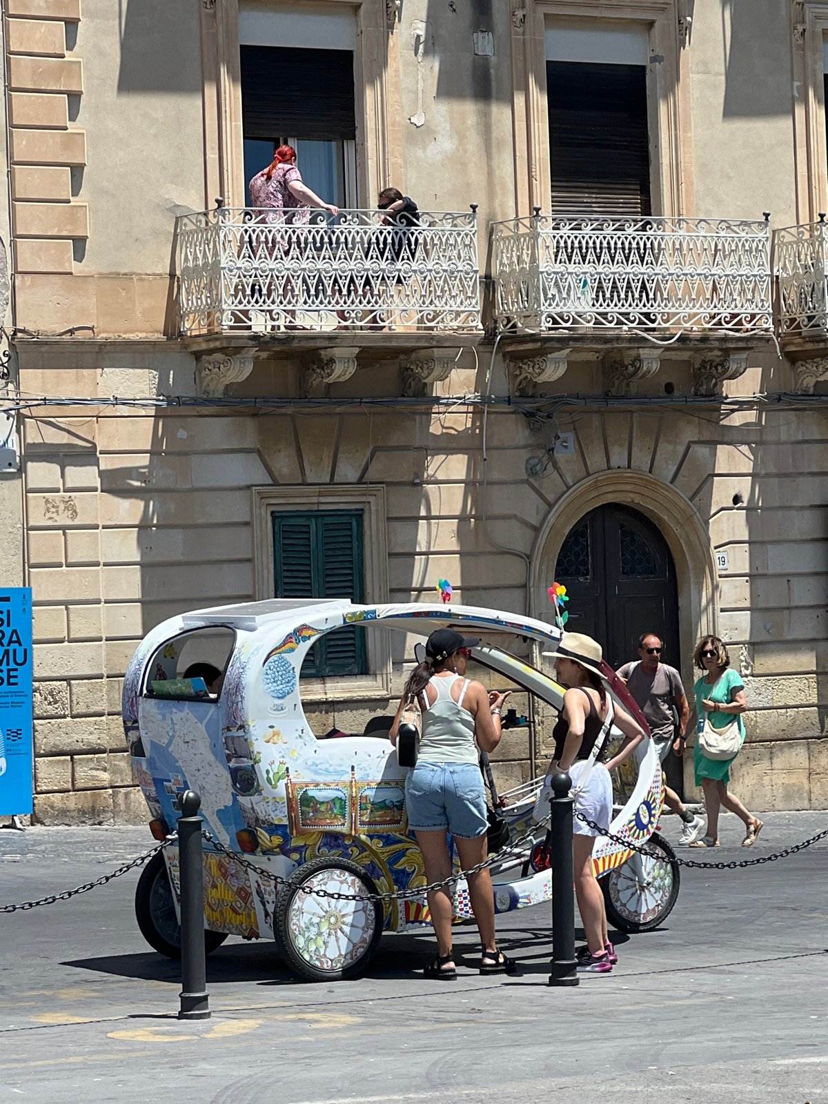 Exploring Syracuse's historic Ortigia district on sunny afternoon