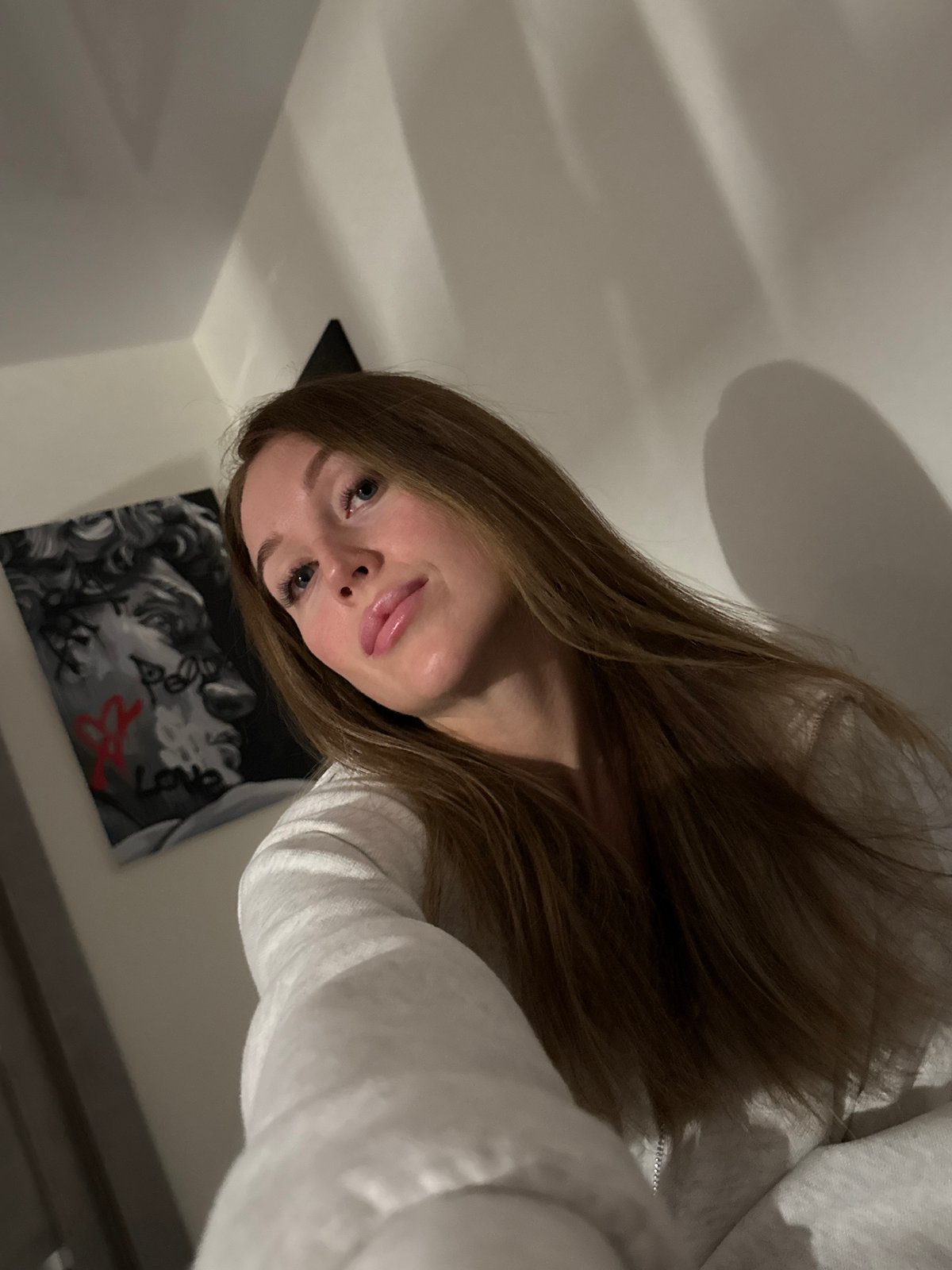 Woman takes selfie in gray hoodie in Chaikovsky, Russia